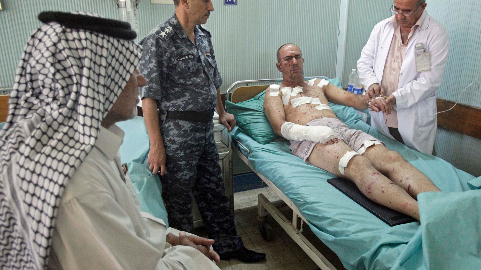 September 14: An Injured man receives treatment at a Hospital in Hillah, about 60 miles (95 kilometers) south of Baghdad, Iraq. A car bomb went off outside a restaurant where local police were having breakfast Wednesday morning, killing and wounding scores of people, police said.