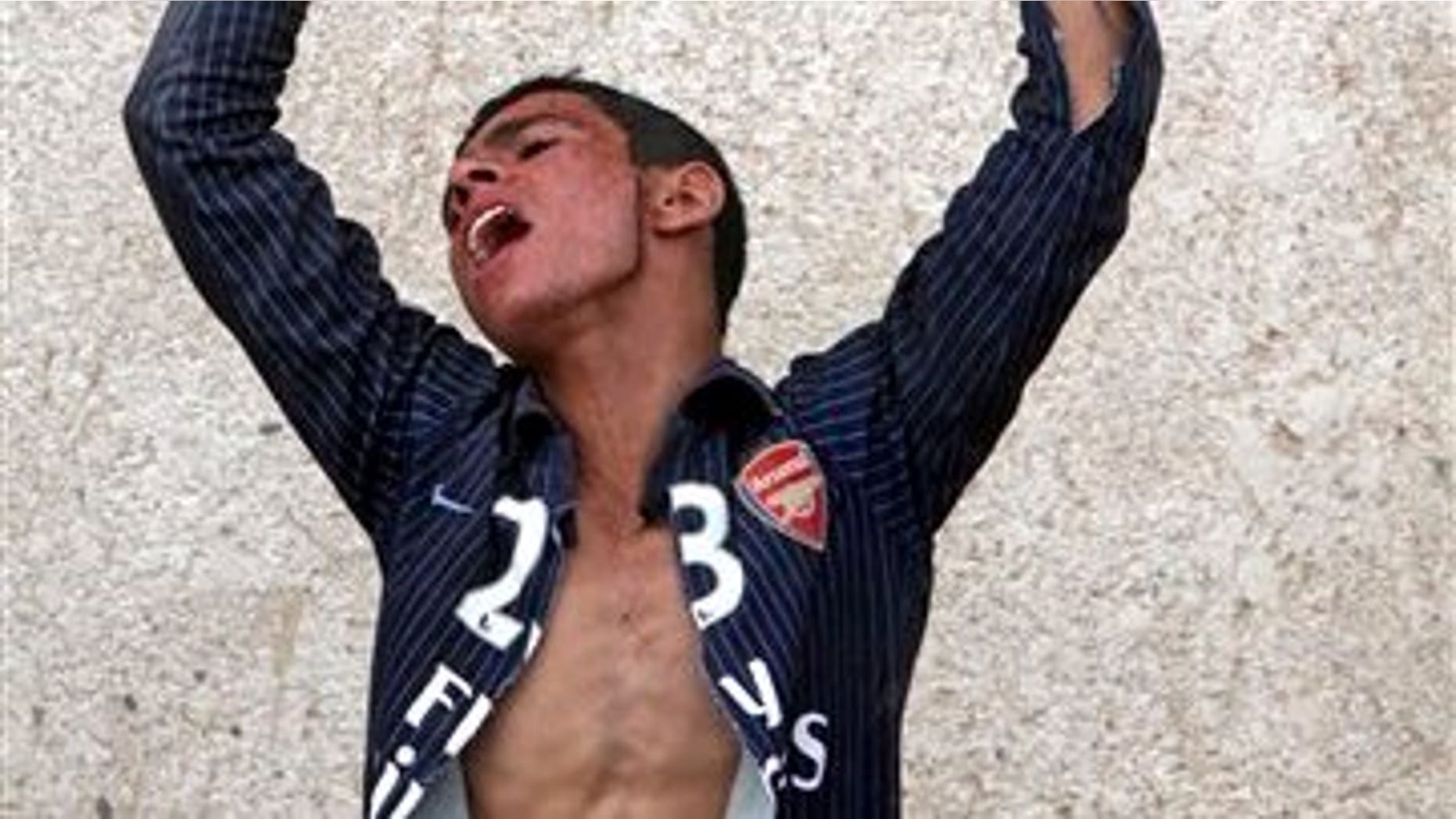 June 6: Ali Majeed, 16, reacts during the funeral for his father, Mohammed, 50, in the Shiite holy city of Najaf 160 kilometers (100 miles) south of Baghdad, Iraq. Mohammed was killed when a car bomb exploded outside a Baghdad police station Sunday in the deadliest of a pair of attacks that killed six people, police said.