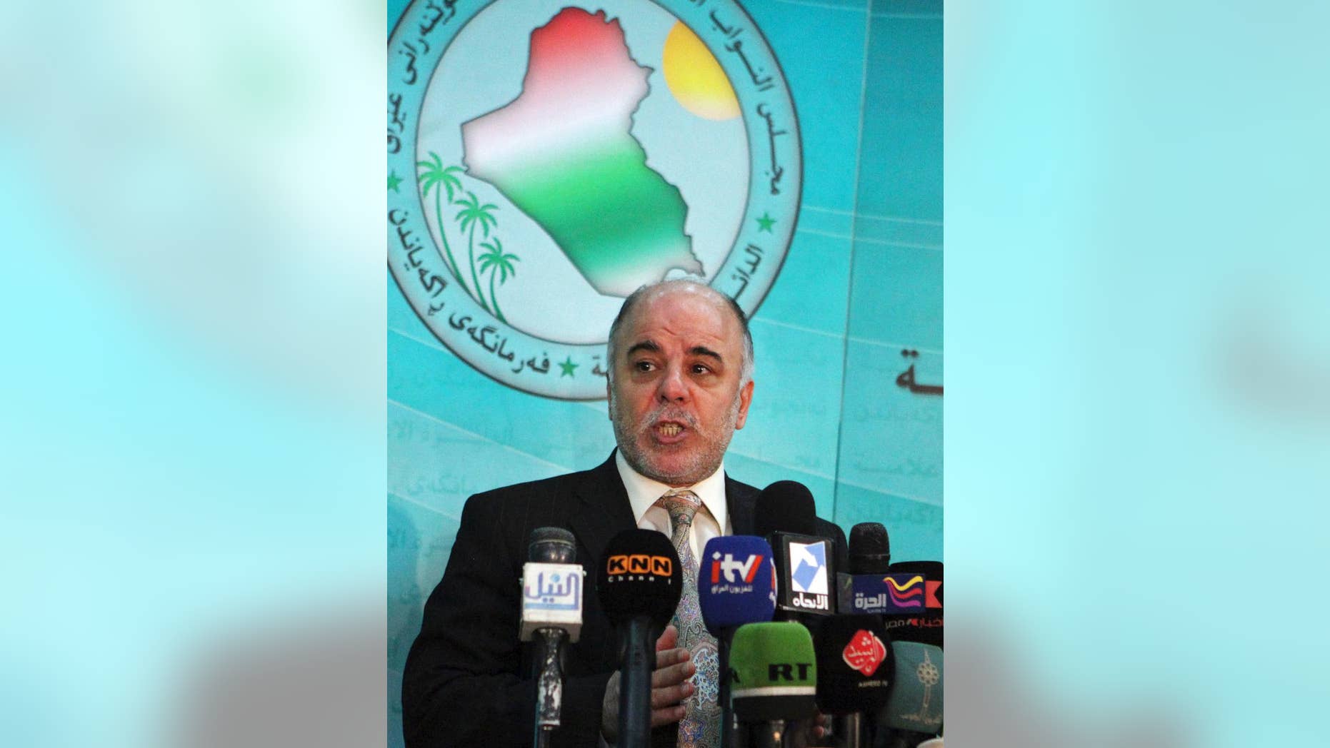 FILE - In this Saturday, Dec. 5, 2009 file photo, Shiite lawmaker Haider al-Abadi speaks to the press after an Iraqi Parliament session about the election law in Baghdad, Iraq. On Monday, Aug. 11, 2014, Iraq's largest coalition of Shiite political parties chose the Deputy Parliament Speaker Haider al-Ibadi to be its candidate to lead the government in a major defeat for incumbent Prime Minister Nouri al-Maliki just hours after he declared himself the rightful candidate and put troops on the street. Critics say the Shiite al-Maliki contributed to the crisis by monopolizing power and pursuing a sectarian agenda that alienated the country's Sunni and Kurdish minorities. (AP Photo/Karim Kadim, File)