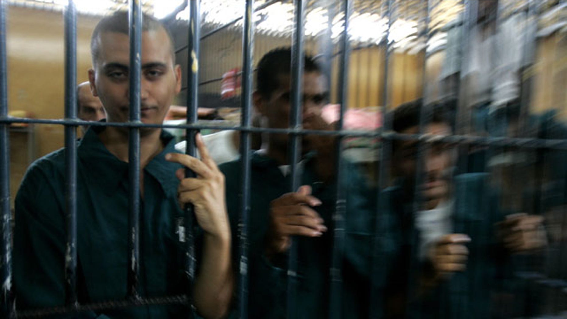 Aug. 28, 2007: Prisoners look out of their cell in the Rusafa 5 intake prison inside the new judicial Green Zone in Baghdad, Iraq. Military documents in the biggest leak of secret information in U.S. history suggest that U.S. forces often failed to follow up on credible evidence that Iraqi forces mistreated, tortured and killed their captives as they battled a violent insurgency.