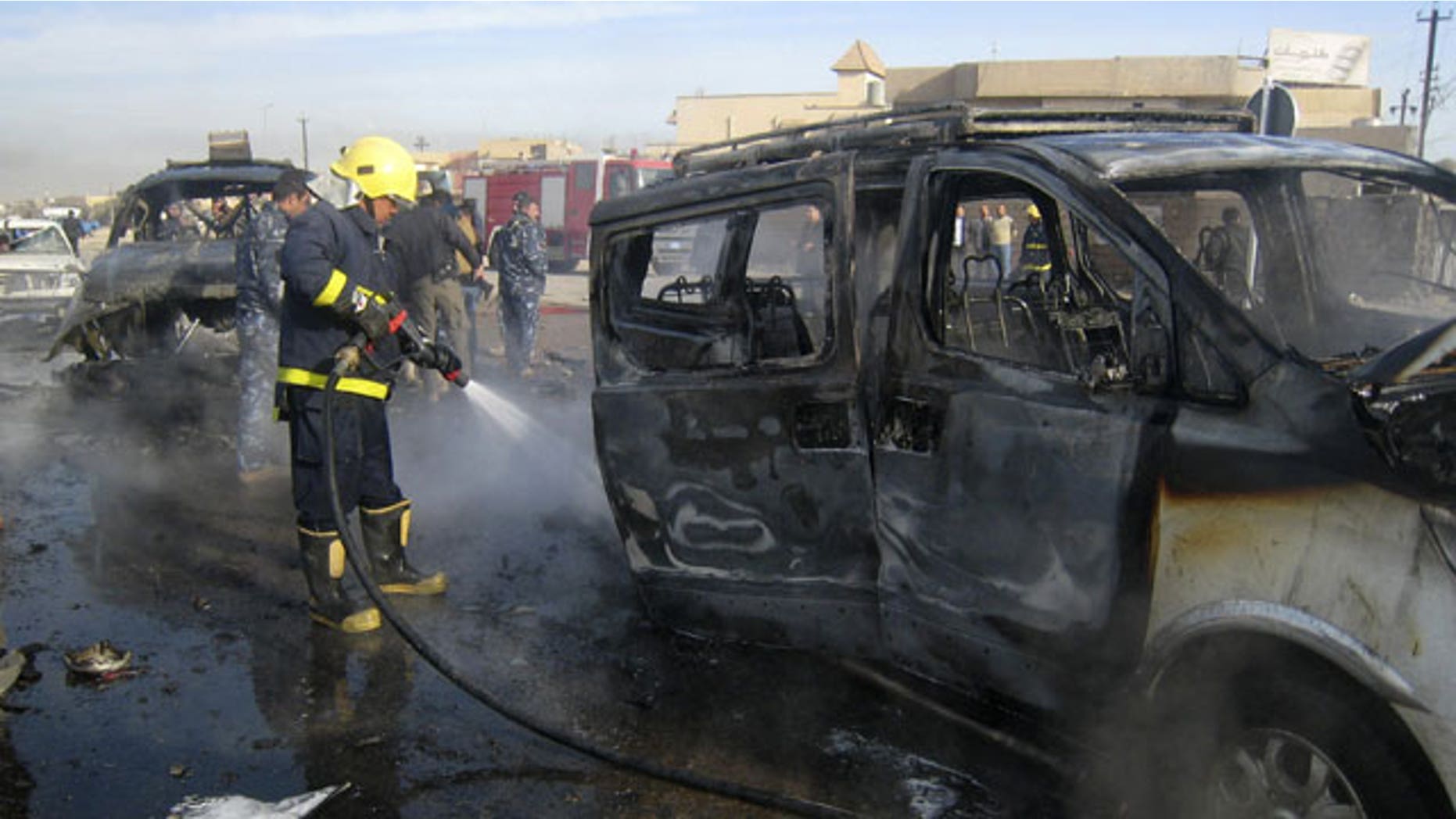 Feb. 23, 2012: An Iraqi firefighter hoses down a burned bus after a car bomb attack in Kirkuk, 290 kilometers (180 miles) north of Baghdad, Iraq. A rapid series of attacks spread over a wide swath of Iraqi territory killed and injured dozens of Iraqis on Thursday, targeting mostly security forces.