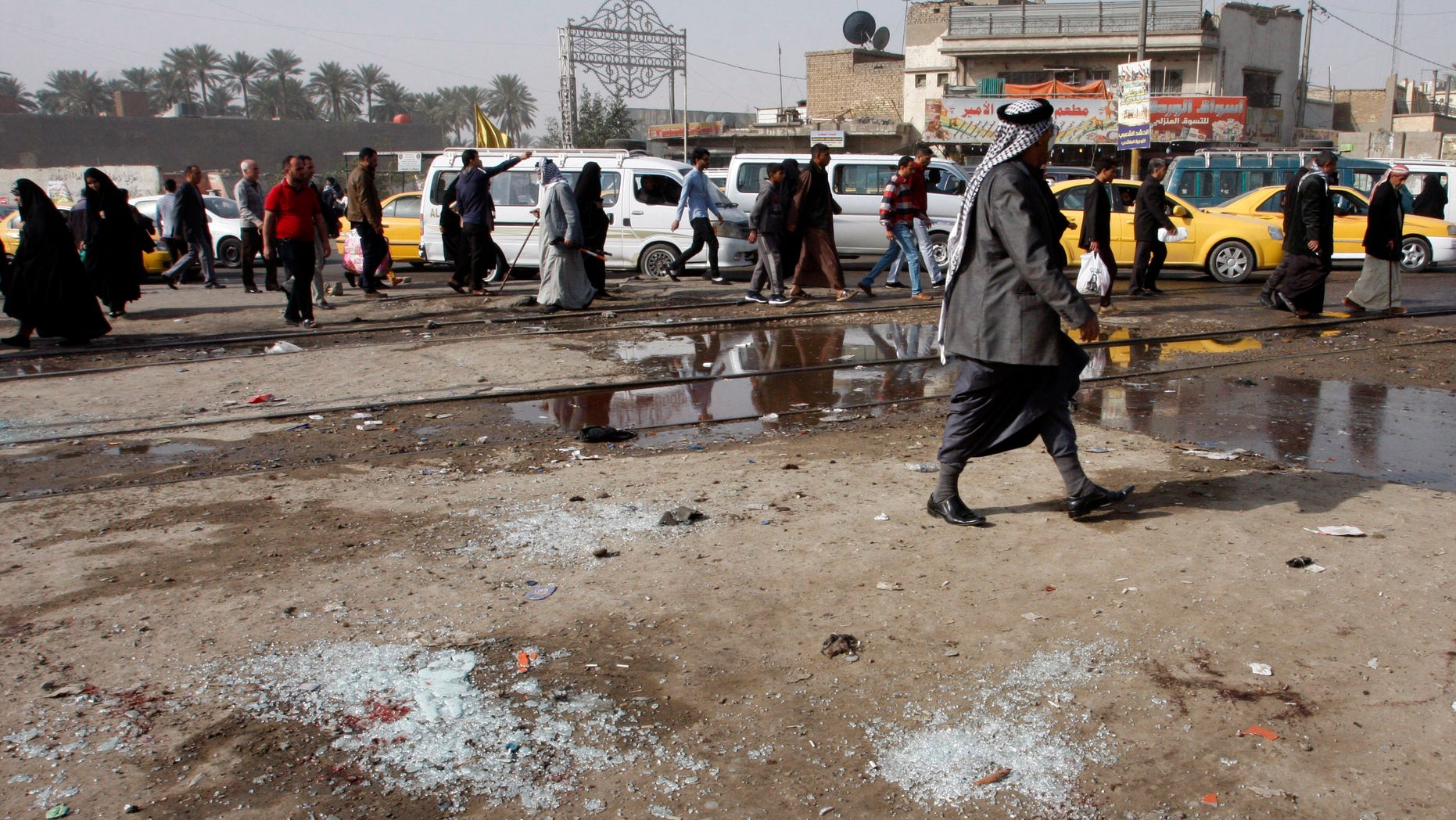 Feb. 9, 2015 - Broken glass at the scene of a suicide bomb attack at Adan Square, in a predominantly Shiite part of Baghdad, Iraq. The attack and another in the northeastern suburb of Husseiniyah in Baghdad killed at least 22 people and wounded dozens.