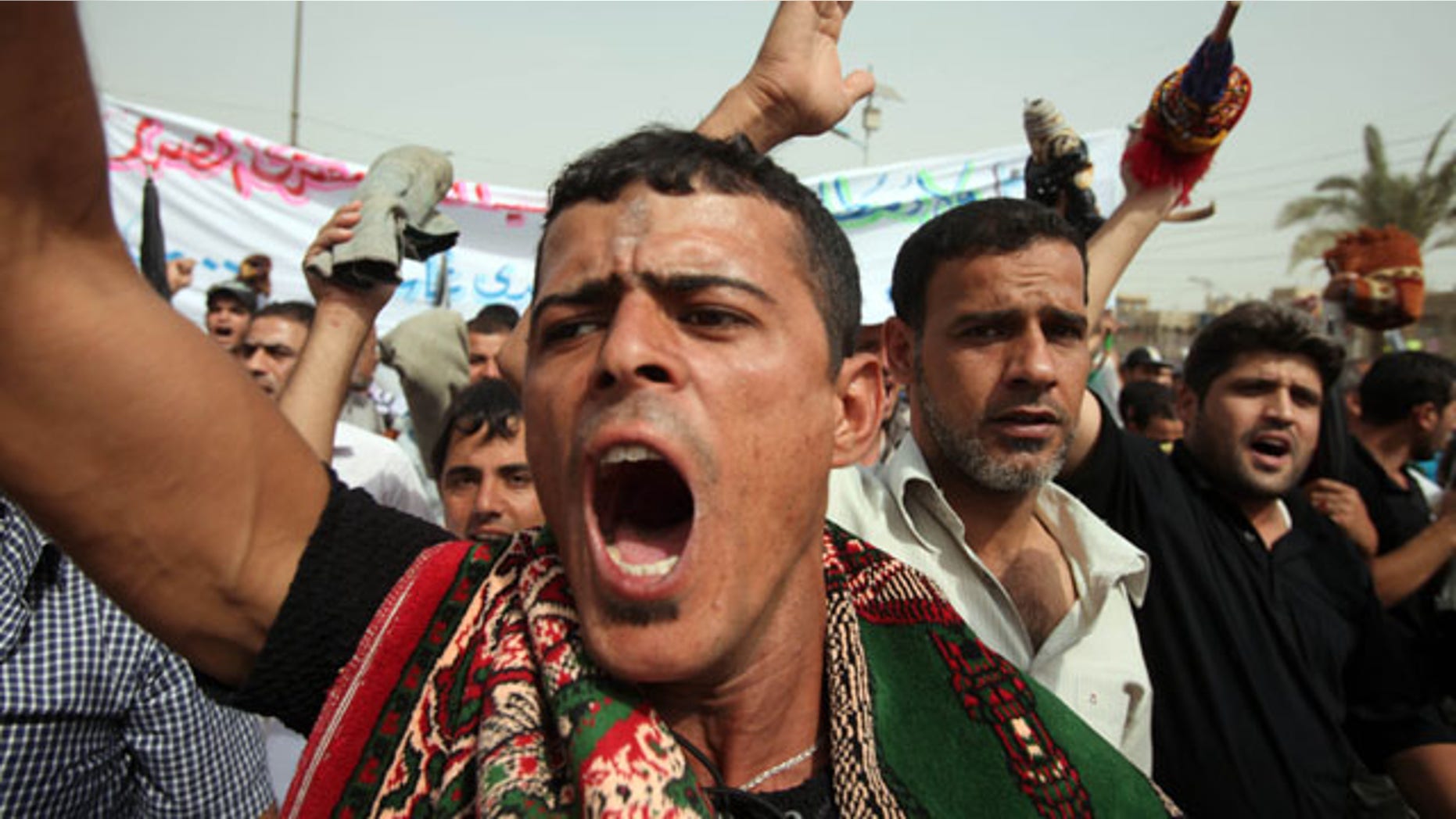 Oct. 8, 2010: Supporters of Shiite cleric Muqtada al-Sadr hold a demonstration in support of al-Sadr's political alliance with Prime Minister Nouri al-Maliki after Friday prayers in the Sadr City area of Baghdad, Iraq.
