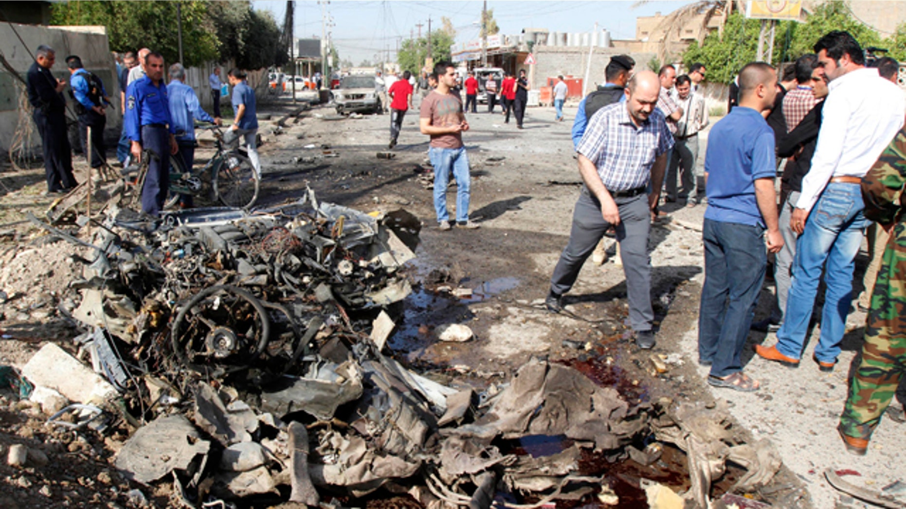 April 15, 2013: Iraqi security personnel are seen at the site of a bomb attack in Kirkuk.