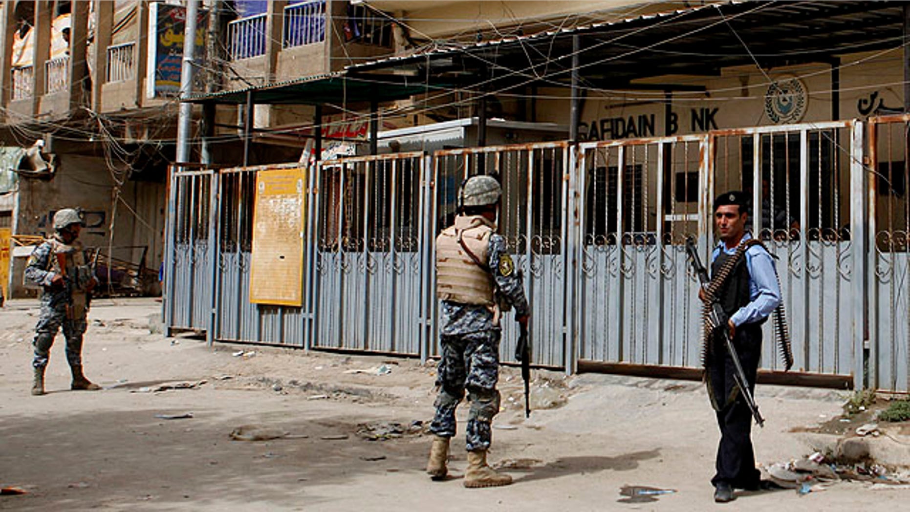Sept. 30, 2010: Iraqi policemen stand guard outside the branch of the state-run al-Rafidain bank in southwestern Baghdad, Iraq.