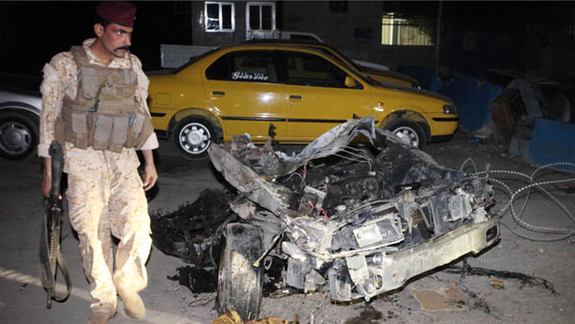 Nov. 2, 2010: An Iraqi Army soldier stands next to wreckage from a car bomb in the Shiite neighborhood of Sadr City in Baghdad, Iraq.