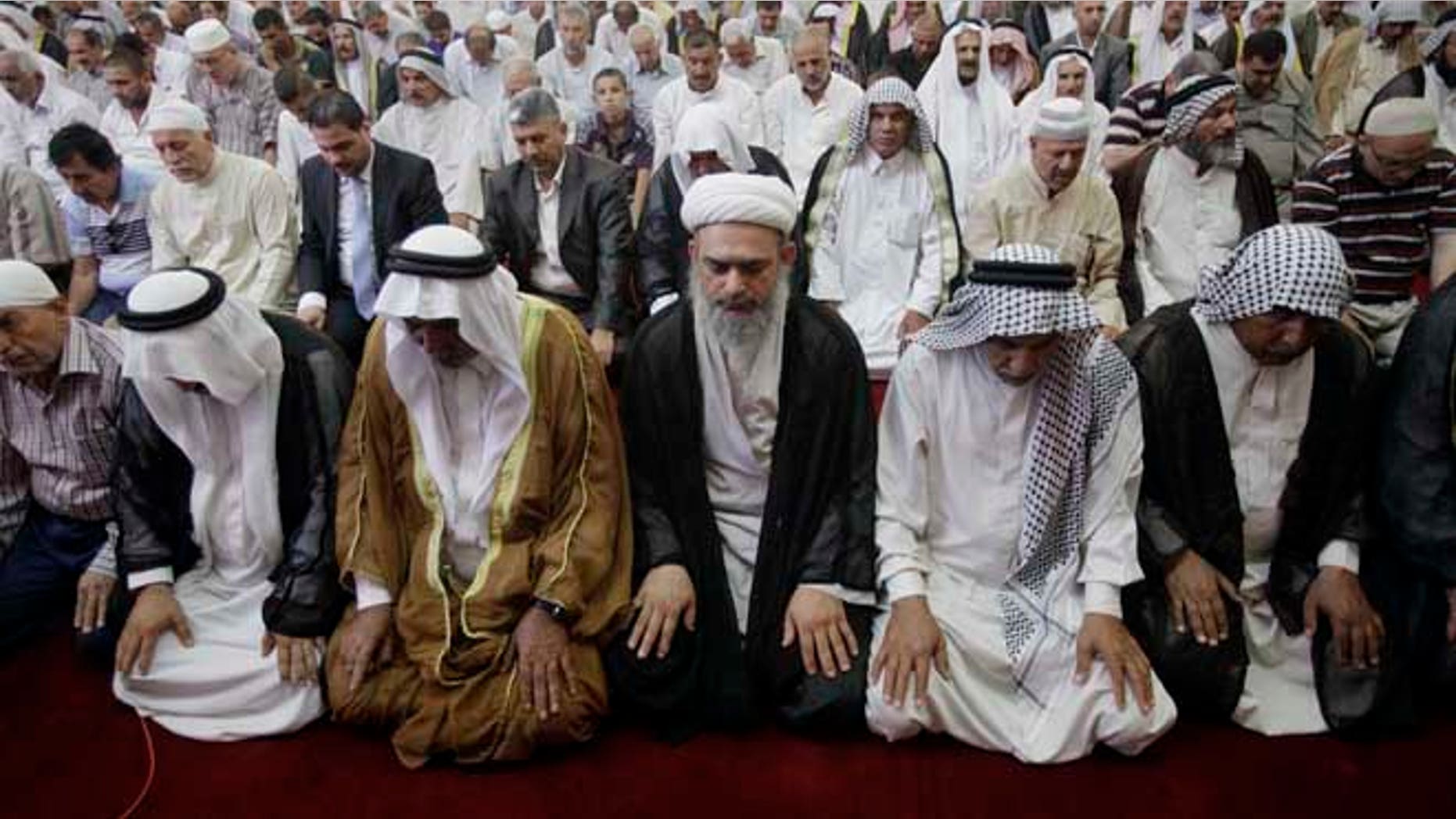 July 5, 2013: Worshippers attend joint Sunni-Shiite Friday prayers at Abdul-Qadir al-Gailani Mosque in Baghdad, Iraq. In a show of national unity, Shiite and Sunni worshippers held joint prayers Friday in a Sunni mosque in downtown Baghdad amid tight security measures.