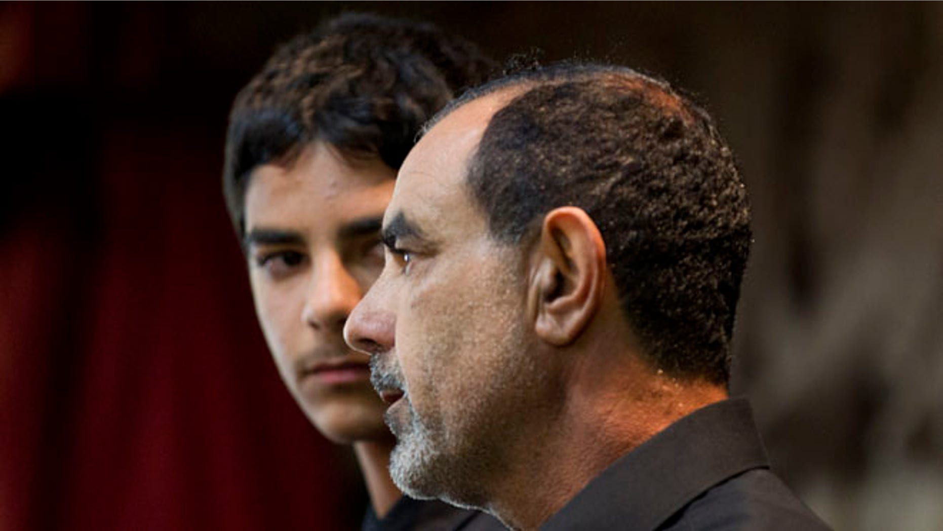 March 27, 2012: In this file photo showing Kassim Alhimidi, right, speaks alongside his son, Mohammed Alhimidi, during a memorial for his wife, Shaima Alawadi at a mosque in Lakeside, Calif.