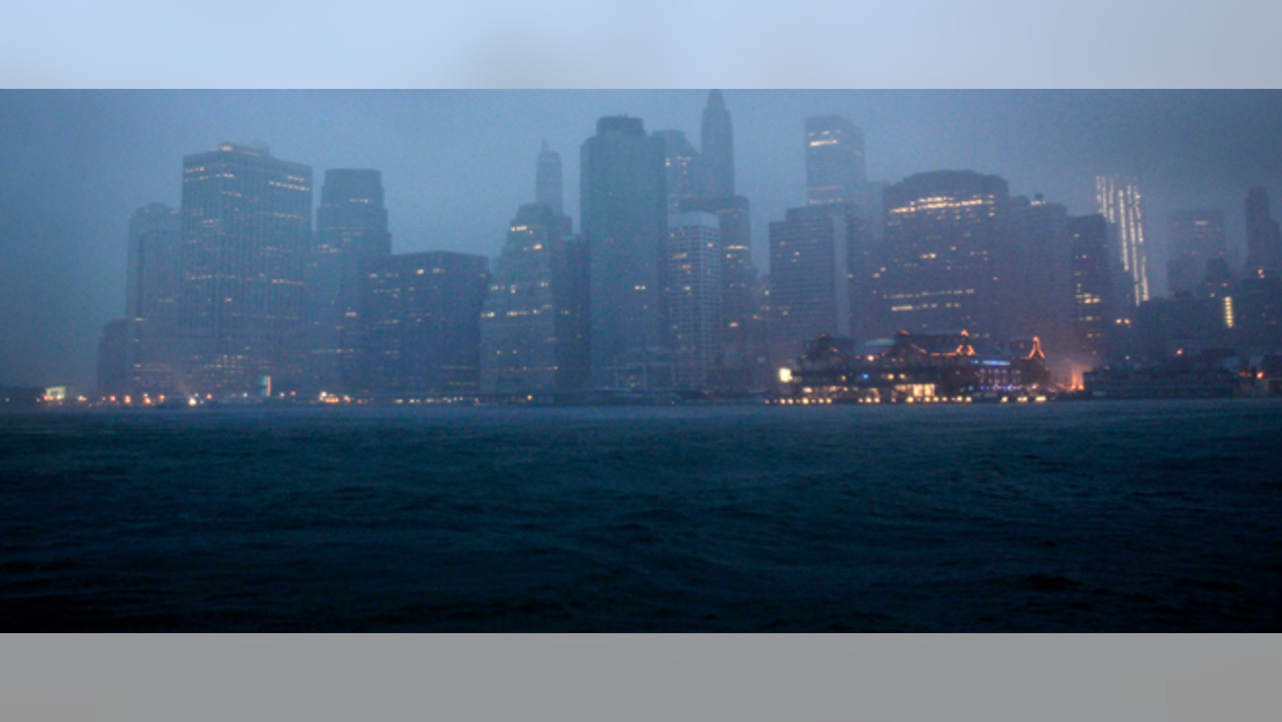 Lower Manhattan is seen amidst dark clouds in New York, Sunday, Aug. 28, 2011. Hurricane Irene bore down on a dark and quiet New York early Sunday, bringing winds and rapidly rising seawater that threatened parts of the city. The rumble of the subway system was silenced for the first time in years, the city all but shut down for the strongest tropical lashing since the 1980s. (AP Photo/Seth Wenig)