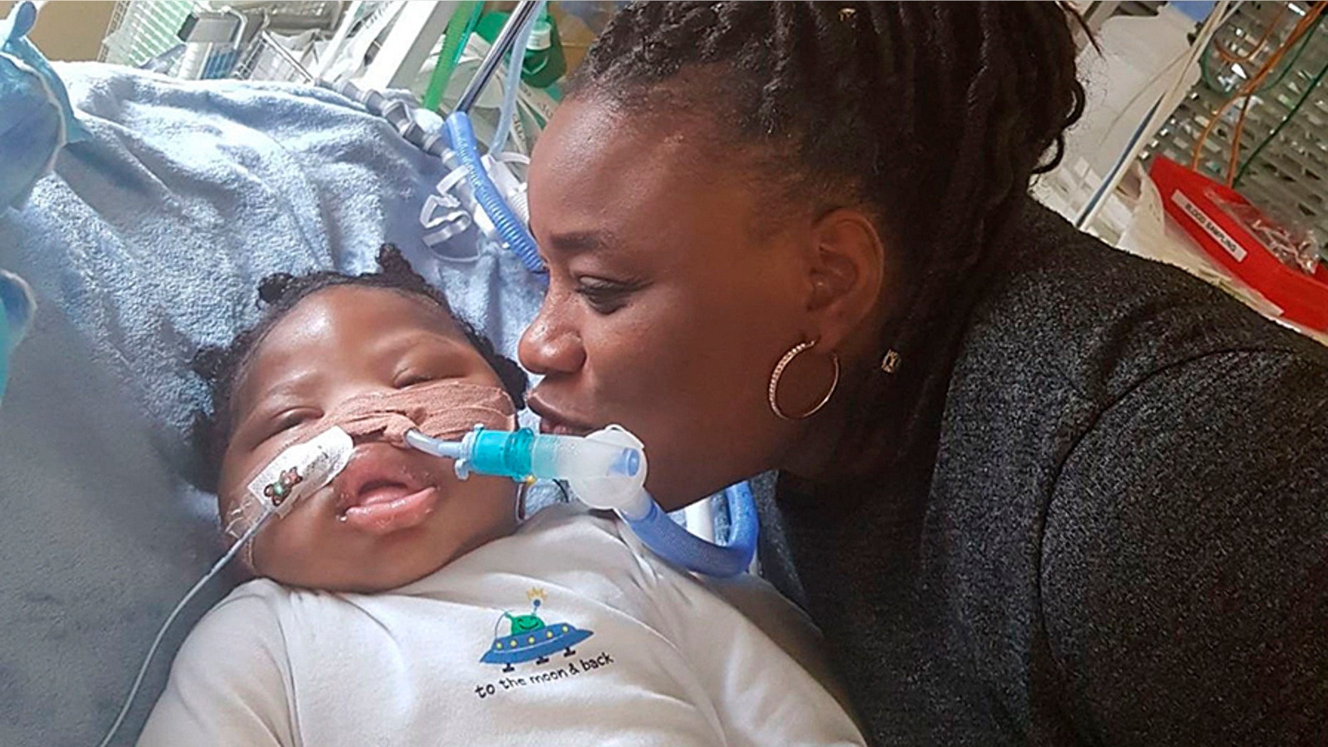 Isaiah Haastrup with his aunt Dahlia Thomas at King's College Hospital in London. A judge ruled that the 11-month-boy could be taken off life support despite the parents' objection.