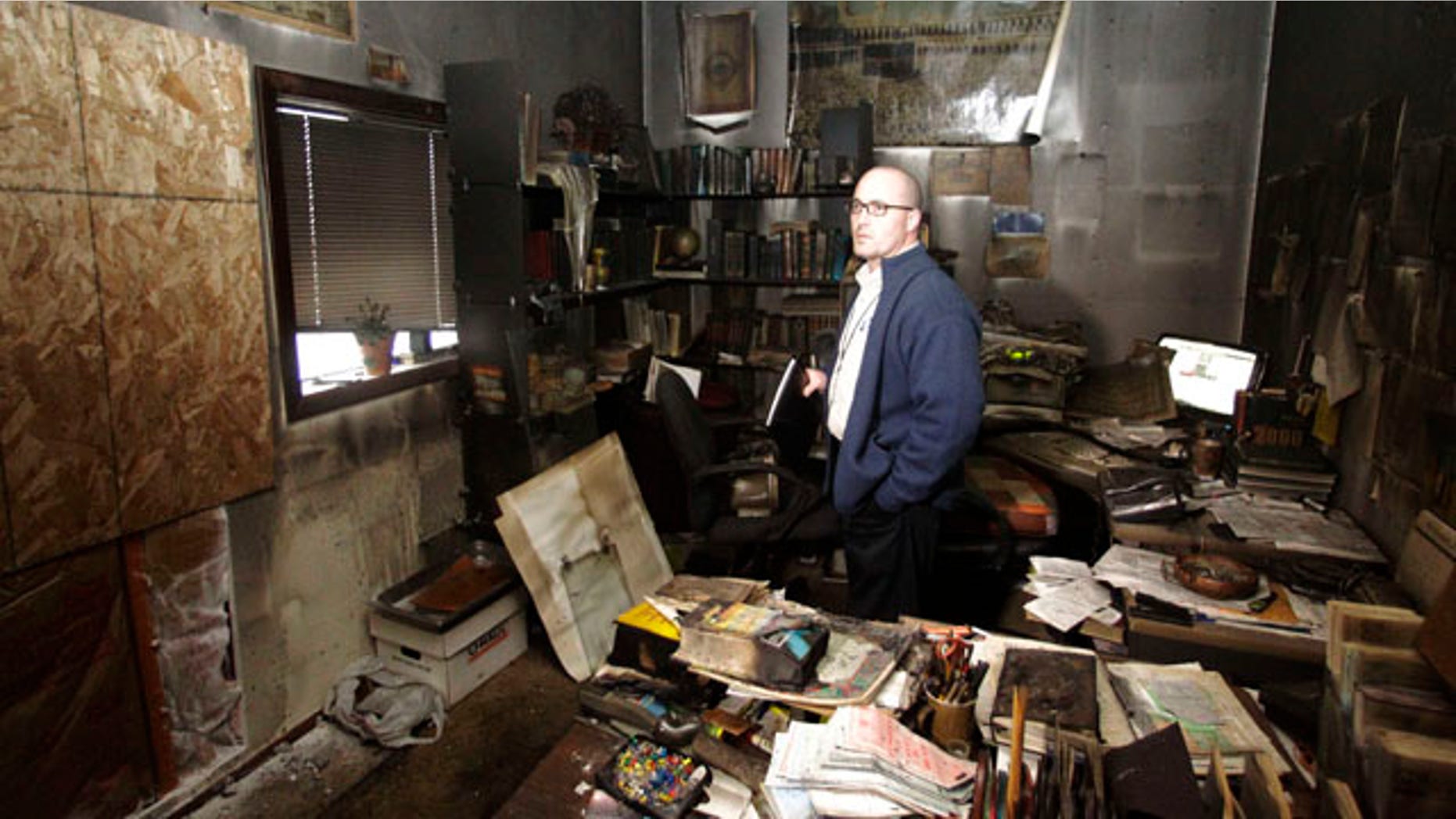 Nov. 28: Cpt. Jonathan Sassman of the Corvallis Police Department looks over fire damage at the Salman Al-Farisi Islamic Center in Corvallis, Ore., where an alleged arsonist set a fire in the early morning hours.
