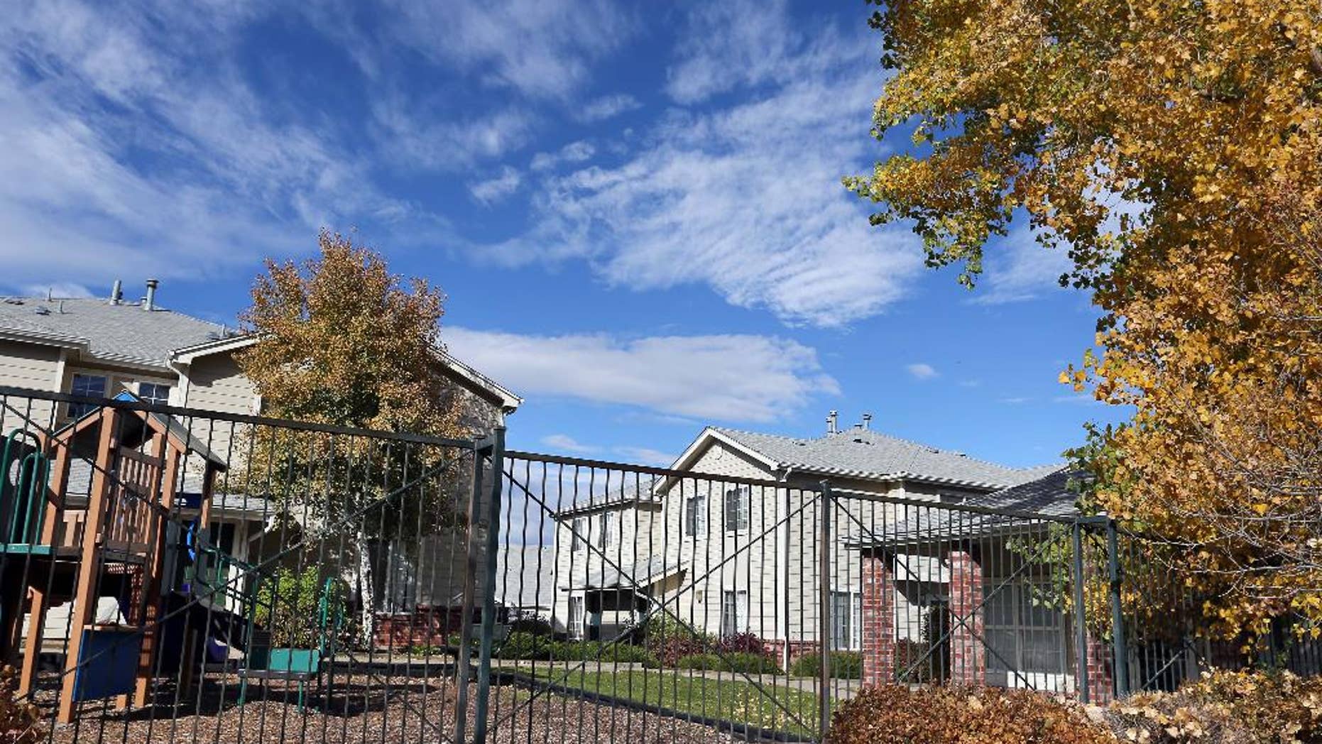 FILE - This Wednesday, Oct. 22, 2014, file photo shows the apartment complex in Aurora, Colo., which police say is the home of one of the three teenage girls who, according to U.S. authorities, were en route to join the Islamic State group in Syria when they were stopped at an airport in Germany. On Thursday, Nov. 13, 2014, a member of the National Counterterrorism Center from Washington, D.C. spoke to parents and Muslim leaders in Denver about the ease with which their children can be radicalized on the Internet. The meeting was the first of authorities' outreach efforts since three teen girls from the neighborhood were stopped from trying to join Islamic State extremists in Syria and resembles similar efforts nationwide to keep kids from going overseas to fight. (AP Photo/Brennan Linsley, File)
