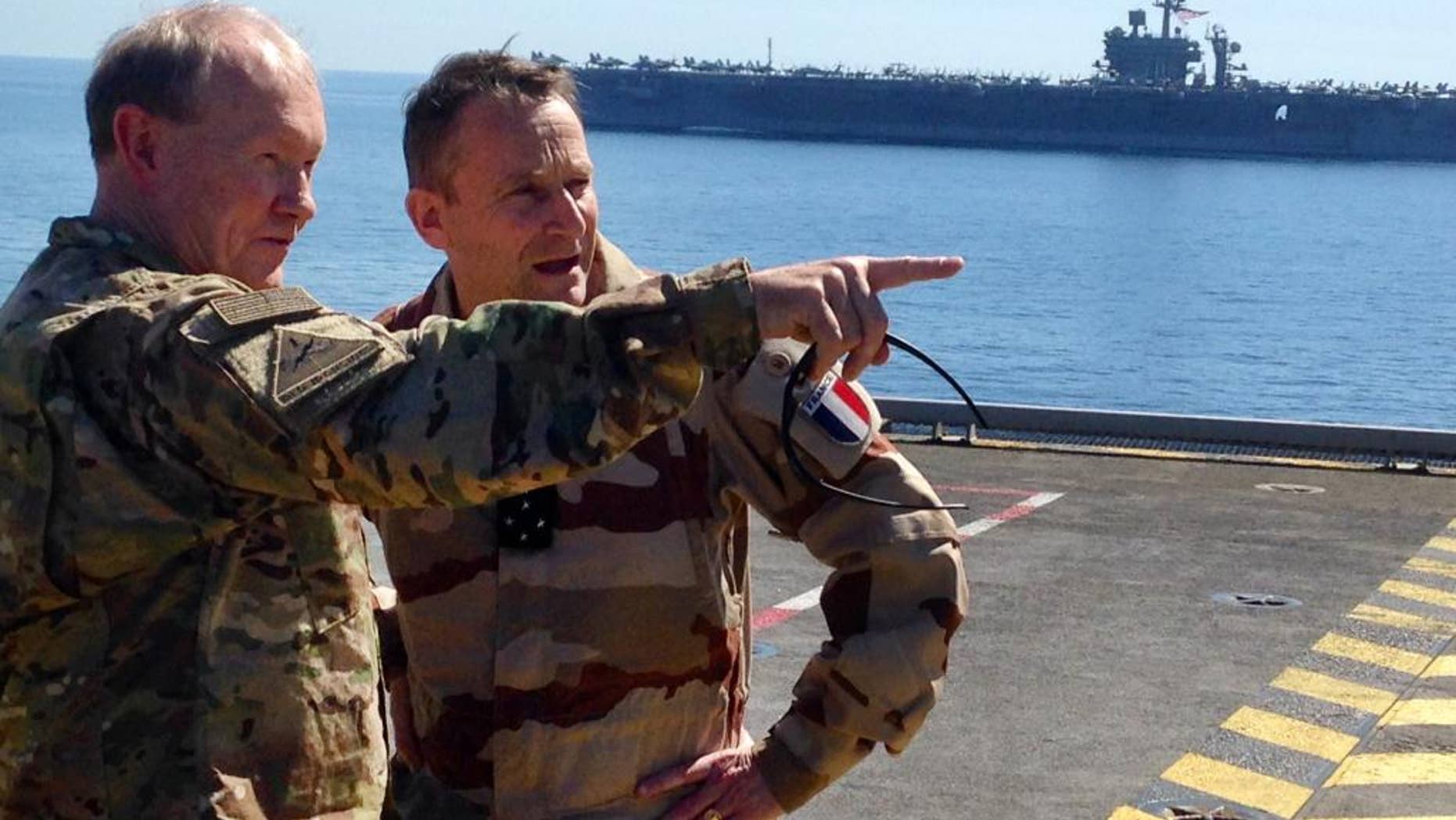 Gen. Martin Dempsey, chairman of the U.S. Joint Chiefs of Staff, left, confers with his French counterpart, Gen. Pierre de Villiers, aboard the French aircraft carrier Charles de Gaulle in the Persian Gulf on Sunday, March 8, 2015. Dempsey says some Iraqi army units in line for U.S.-led training to fight the Islamic State group are showing up ill-prepared. (AP Photo/Bob Burns)