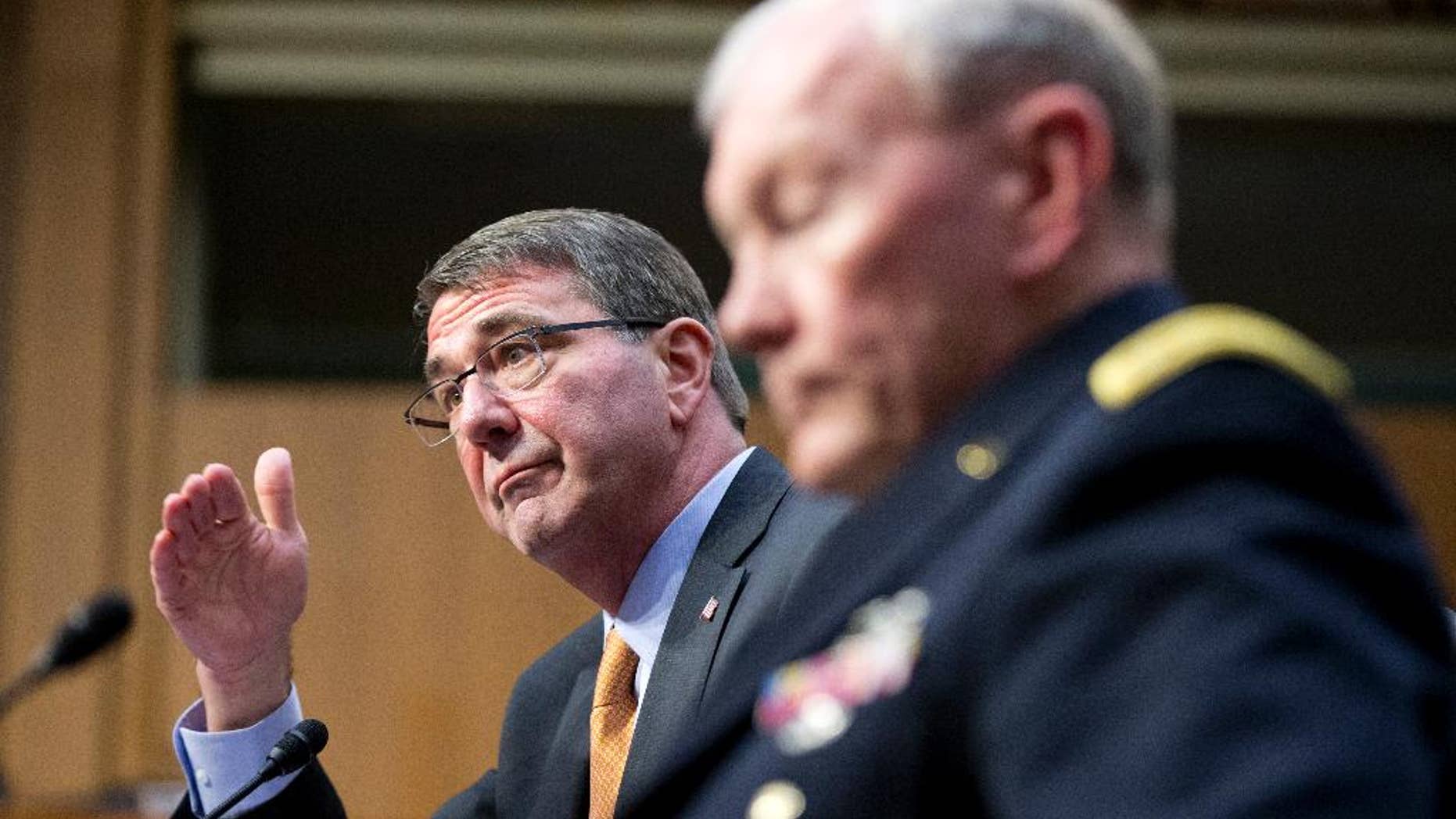 FILE - In this March 3, 2015 file photo, Defense Secretary Ash Carter, left, accompanied by Joint Chiefs Chairman Gen. Martin Dempsey, testifies on Capitol Hill in Washington before the Senate Armed Services Committee. Iran’s growing influence in Iraq is setting off alarm bells, and nowhere is the problem starker than in the high-stakes battle for Tikrit. It marks a crucial fight in the bigger war to expel the Islamic State group from Iraq, and yet Iran and the Shiite militias it empowers _ not the U.S. _ are leading the charge. Carter, under questioning from Sen. John McCain this week, acknowledged his concern when McCain asked if it alarms him that Iran “has basically taken over the fight.” (AP Photo/Manuel Balce Ceneta, File)