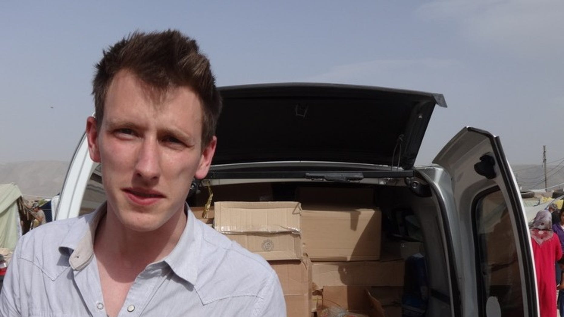 Peter Kassig standing in front of a truck filled with supplies for Syrian refugees. Kidnappers linked to the Islamic State terror network beheaded him in 2014.