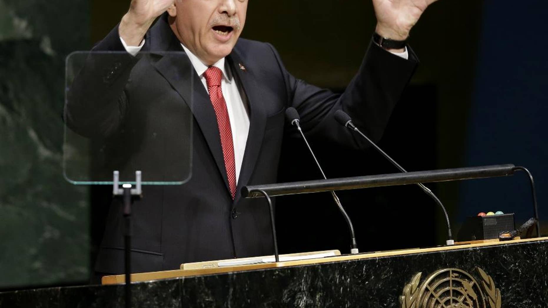 In this Sept. 24, 2014, photo, Turkish President Recep Tayyip Erdogan speaks during the 69th session of the United Nations General Assembly at U.N. headquarters. Moving from reluctance to refusal and finally to acceptance, Turkey is joining its NATO allies and fellow Sunni Muslim nations in a coalition to destroy the Islamic State militant group. But the U.S. is still waiting for details of any new, specific, aid and is warily watching to make sure Ankara keeps its commitments. Erdogan also told reporters on Tuesday, “Of course, we will do our part.” (AP Photo/Seth Wenig)