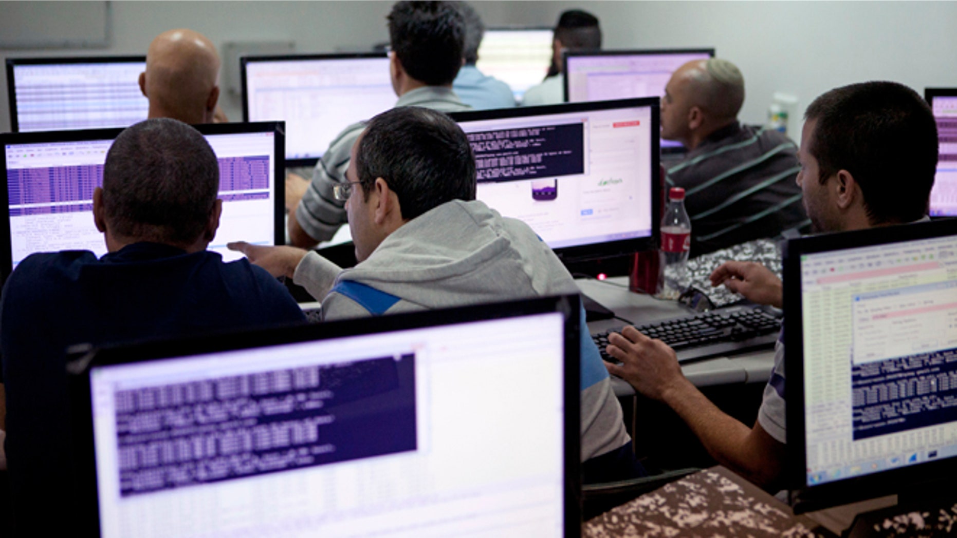 Oct. 20, 2013: Israelis work on computers at the 'CyberGym' school in the coastal city of Hadera. When Israel's military chief delivered a high-profile speech this month outlining the greatest threats his country will face in the future, he listed computer sabotage as a top concern, warning a sophisticated cyber attack could one day bring the nation to a standstill.