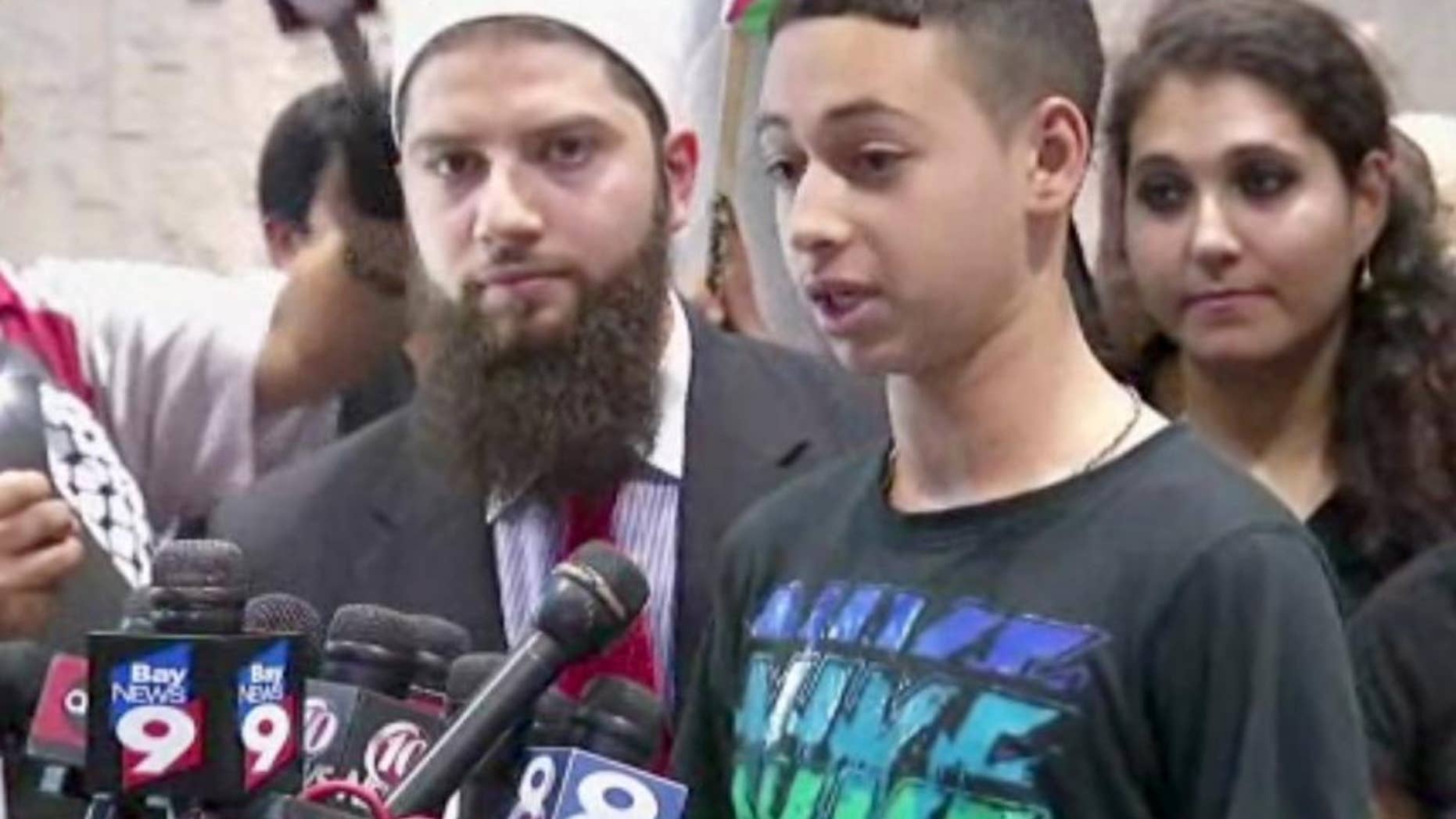 This image from an AP video shows Tariq Abu Khdeir, the Palestinian-American teen who relatives allege was beaten by Israeli authorities earlier this month addressing the media after arriving at at Tampa International Airport on Wednesday night, July 16, 2014, in Tampa, Fla. (AP Photo/AP Video)