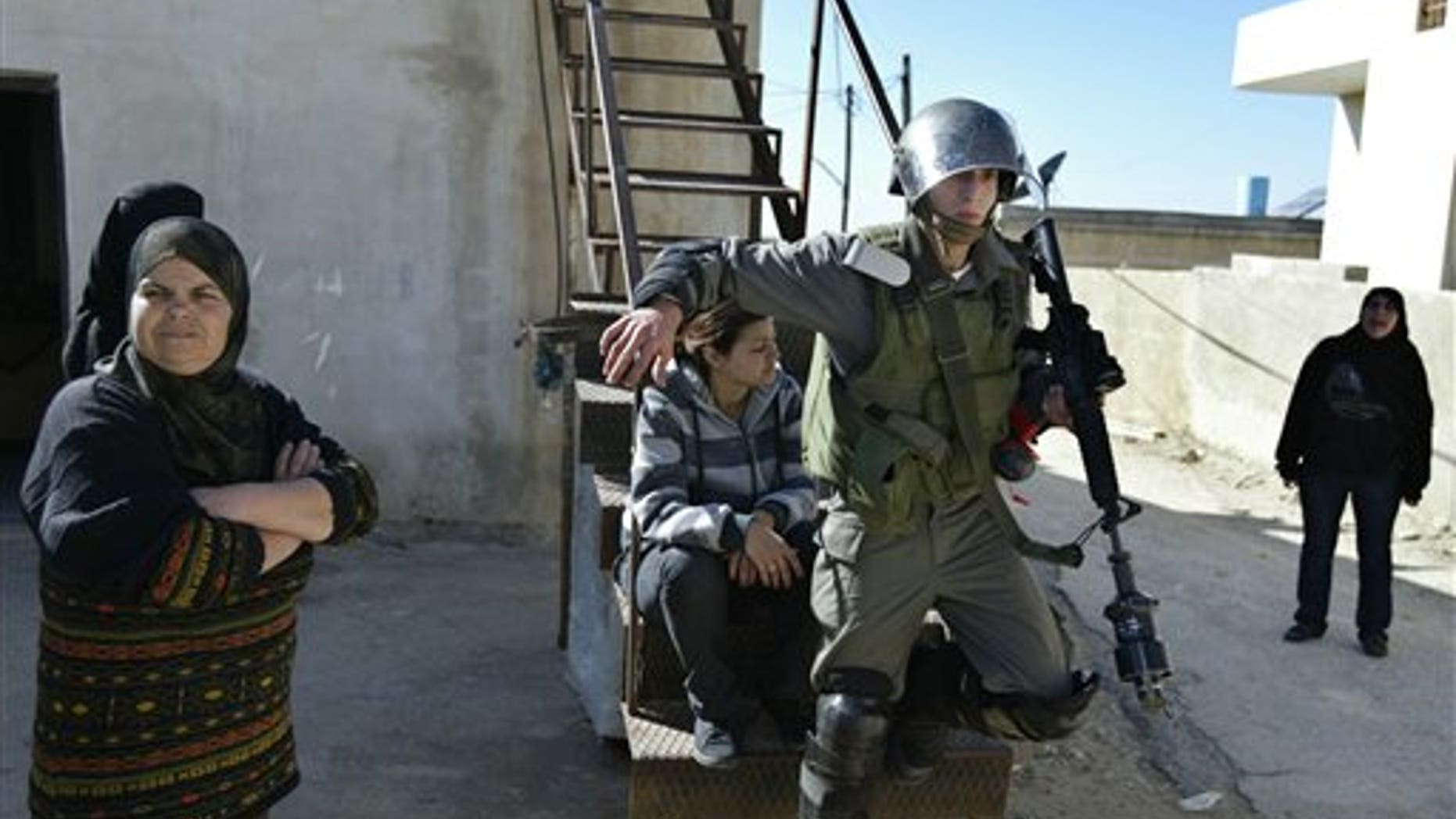 Feb. 18, 2011: An Israeli border police officer walks out from a Palestinian house during clashes with Palestinian demonstrators during a protest against the expansion of the nearby Jewish settlement of Halamish in the West Bank village of Nabi Saleh.