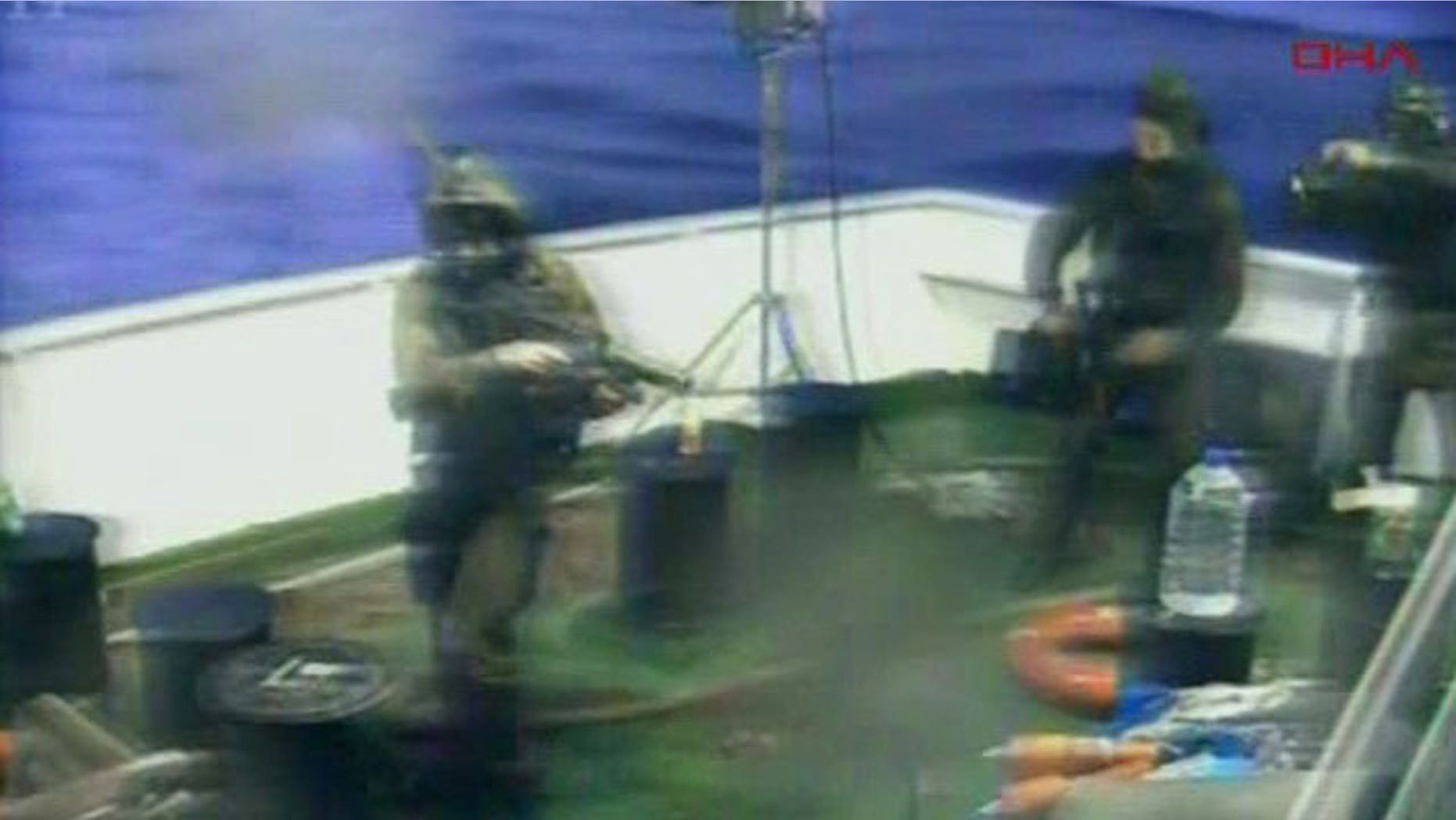 May 31: This video image released by the Turkish Aid group IHH purports to show Israeli soldiers aboard a military vessel in international waters off the Gaza coast surrounding a Turkish ship.