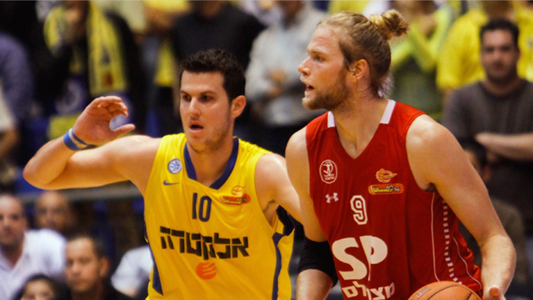 Dec. 2, 2012: In this photo, Maccabi Tel Aviv basketball club captain Guy Pnini, left, and Hapoel Tel Aviv player Jonathan Skjöldebrand, play during a match between the clubs in Tel Aviv.