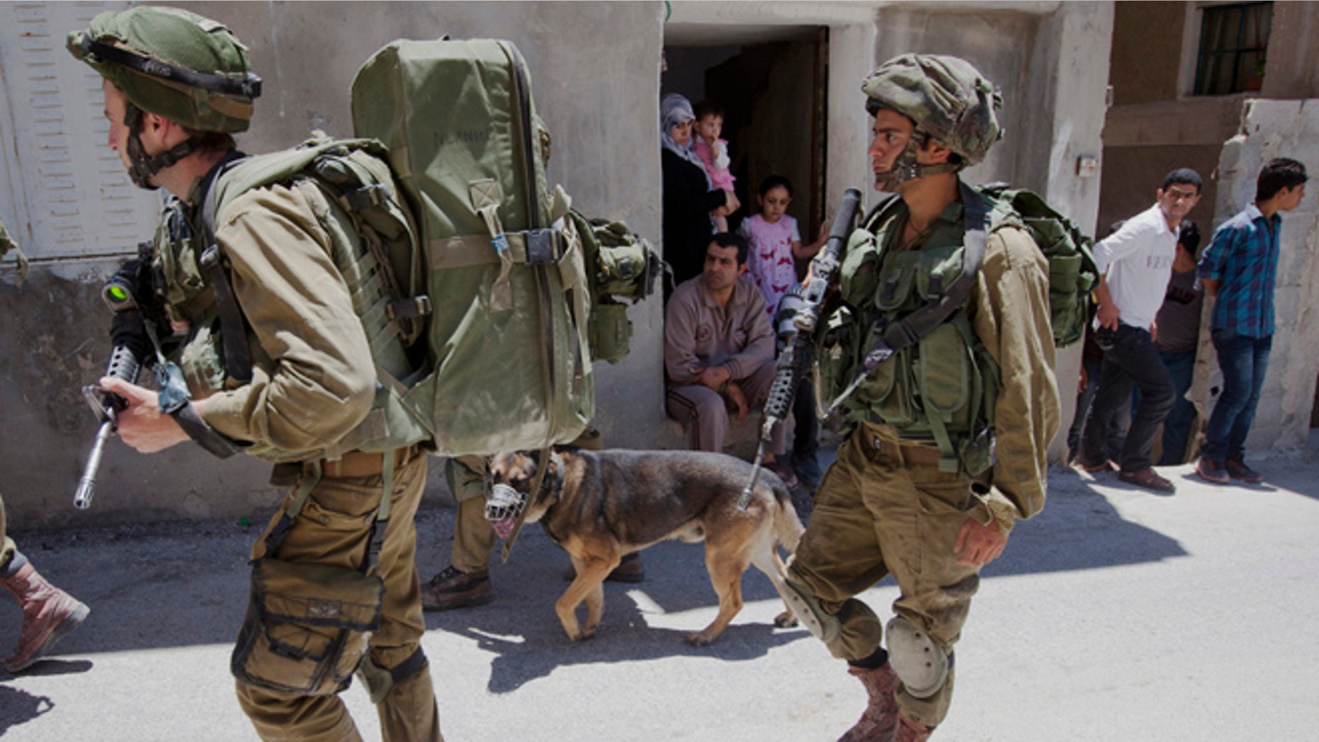 June 15, 2014. Israeli soldiers patrol during a military operation to search for three missing teenagers outside the West Bank city of Hebron.