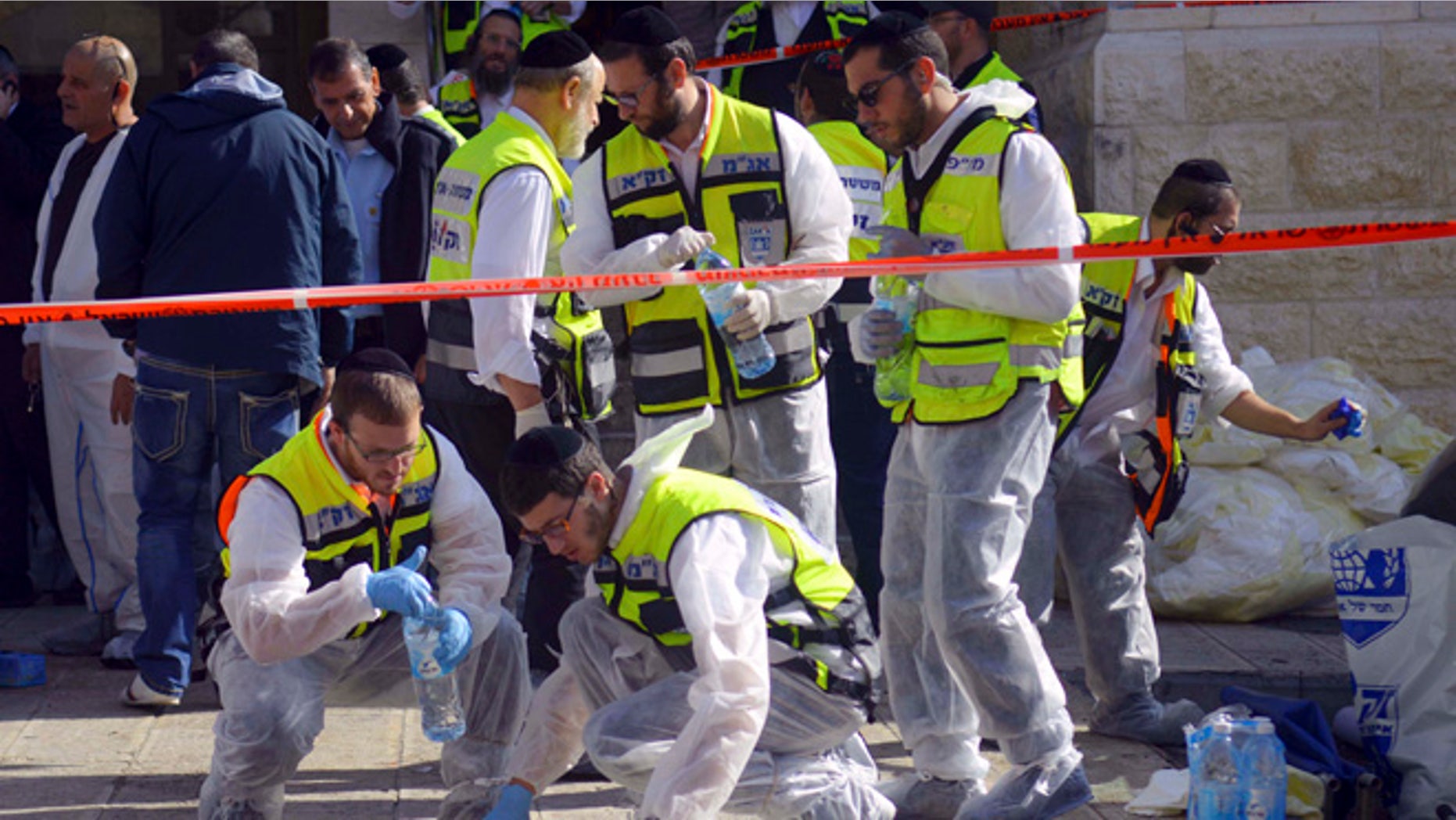 Nov. 18, 2014: Paramedics wipe the blood from pavement outside a synagogue after a shooting attack in Jerusalem. (AP)