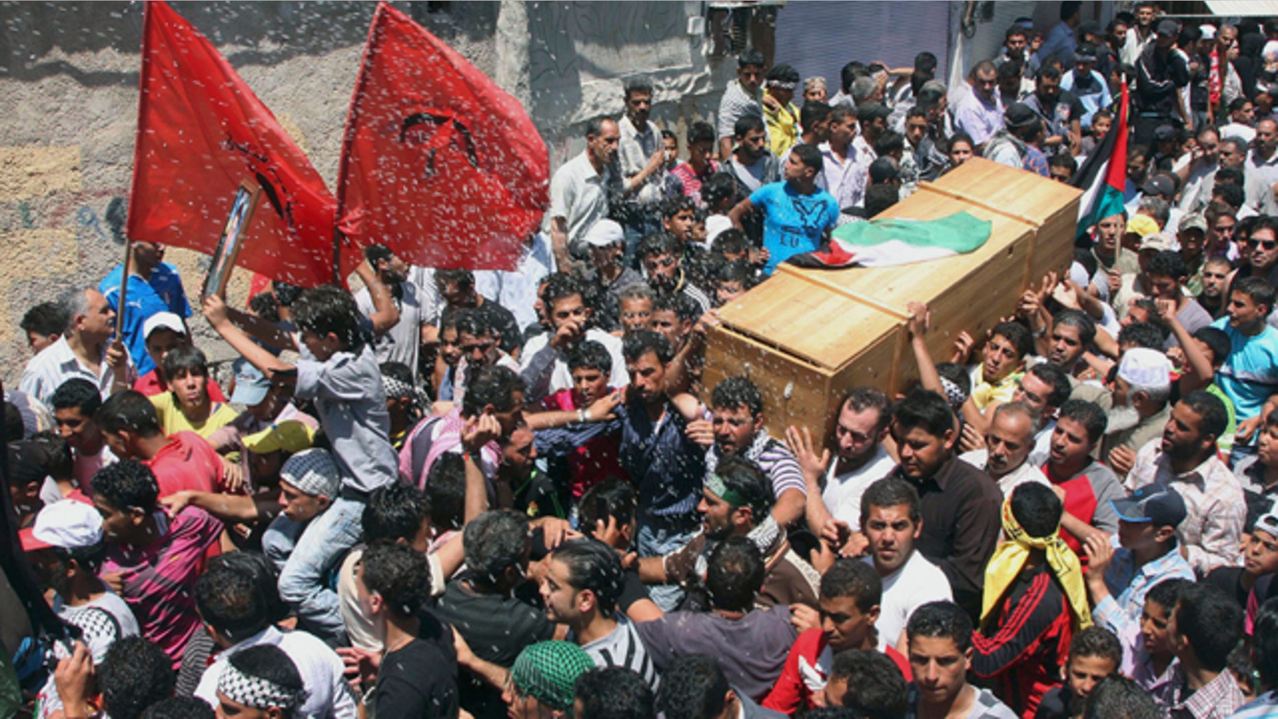 June 6: Palestinian mourners carry the coffin of a Palestinian protester who was killed when Israeli soldiers opened fire on Sunday at protesters who tried to burst across Syria's frontier with the Israeli-controlled Golan Heights, during a funeral procession at Khan al-Shih Palestinian refugee camp, some 25 kilometers far from Damascus, Syria.