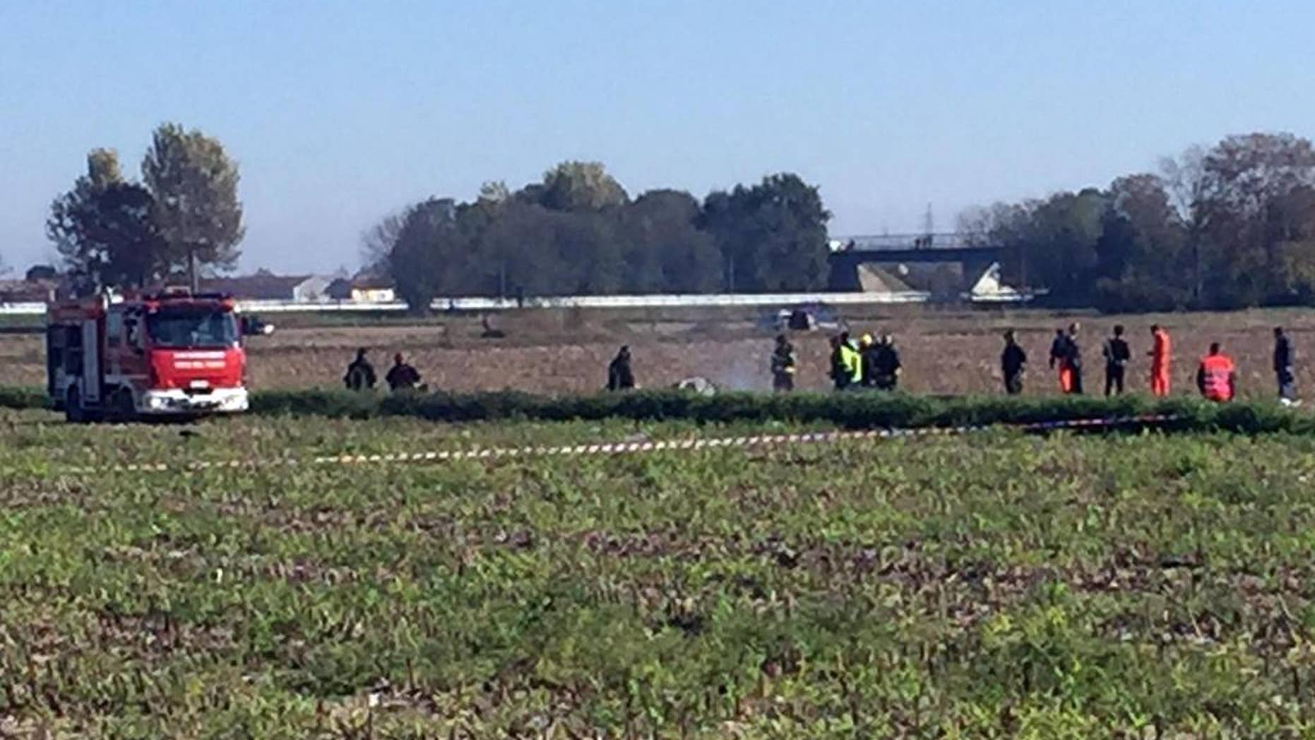 Rescue teams operate in the area where an aircraft crashed in a mid-air incident, in Santhia, near Vercelli, Italy, Friday, Oct. 30, 2015. The AgustaWestland helicopter maker says that a prototype of one of its aircraft was involved in a mid-air accident that killed both occupants in northern Italy. (Roberto Maggio/ANSA via AP) ITALY OUT