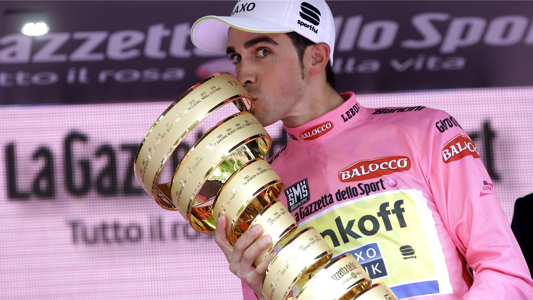 Spain's Alberto Contador kisses the trophy after winning the Giro d'Italia, Tour of Italy cycling race, in Milan, Italy, Sunday, May 31, 2015. Alberto Contador clinched his second Giro d'Italia title on Sunday, remaining on course to become the first cyclist since 1998 to win the Italian classic and the Tour de France in the same year. (AP Photo/Antonio Calanni)