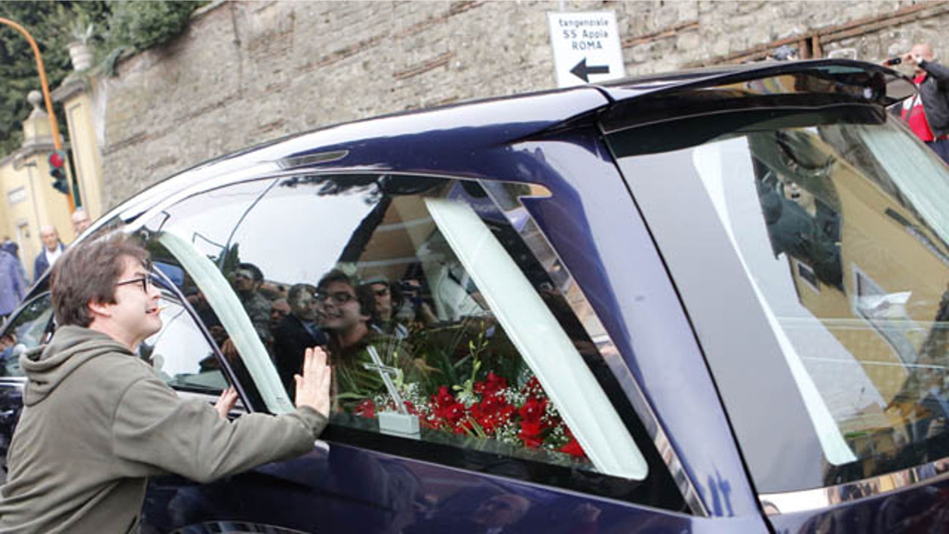 October 15, 2013: A protester bangs his hands on the hearse carrying the coffin of Nazi war criminal Erich Priebke as it arrives at the Society of St. Pius X, a schismatic Catholic group, in Albano Laziale, on the outskirts of Rome Tuesday.