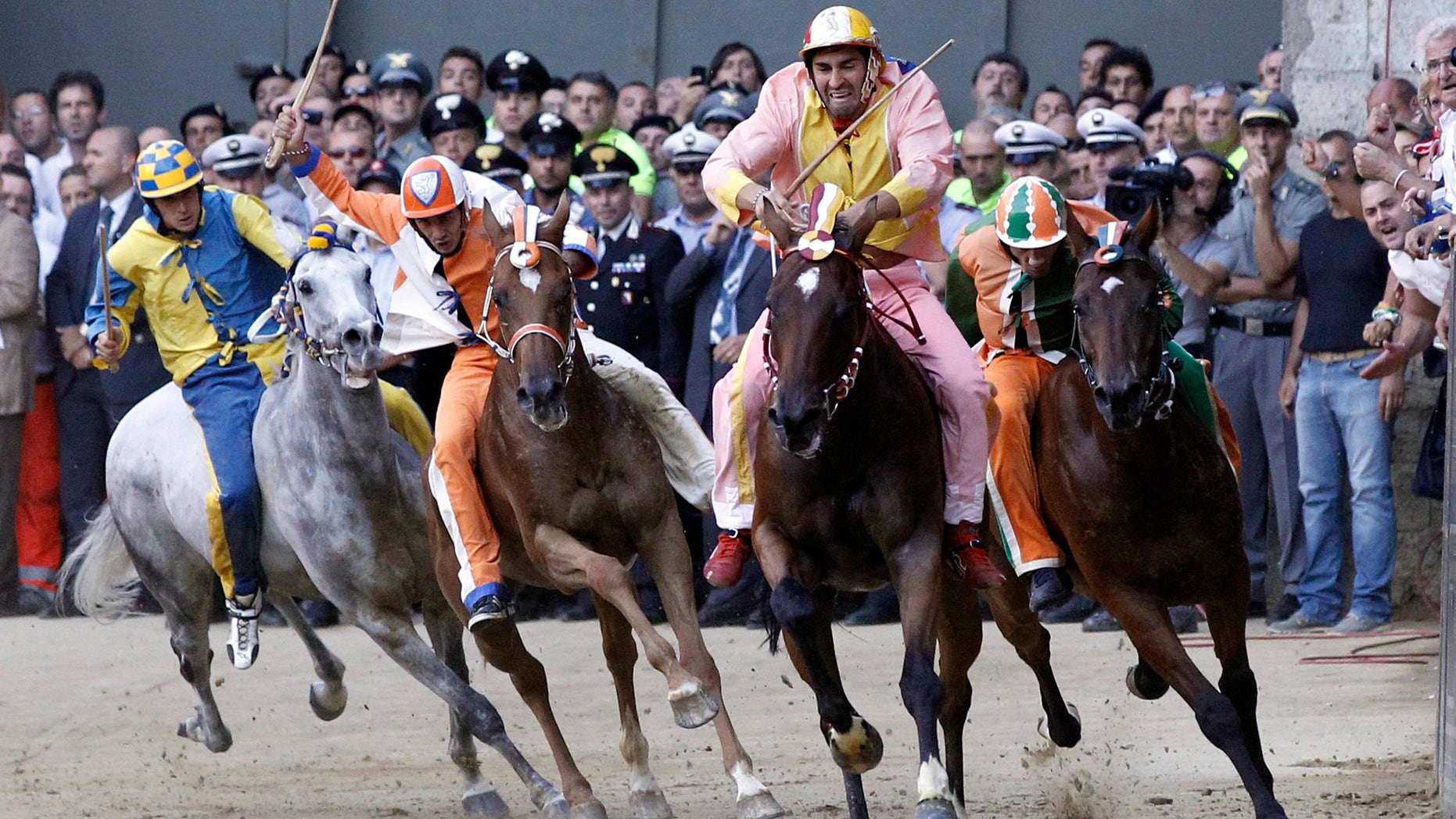 Aug. 16, 2012: The Montone (Ram) neighborhood rider Jonathan Bartoletti, second from right, leads the race on his way to win the Madonna dell'Assunta (Virgin of the Assumption) ancient Palio, the famous break-neck bareback horse race run in Siena's main square, in Siena , Italy.