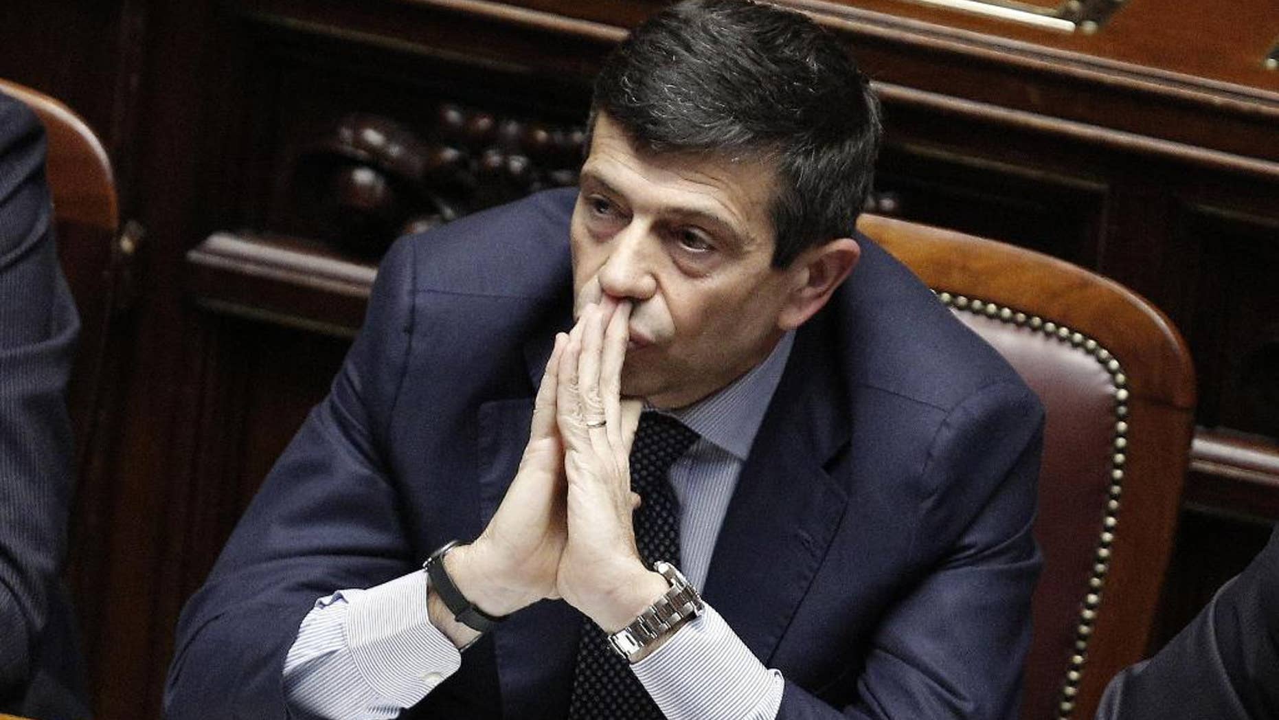 Infrastructure Minister Maurizio Lupi sits at the Lower House before announcing his resignation in Rome, Friday, March 20, 2015. Four people, including the ex-ministry official who oversaw infrastructure projects under seven governments, were ordered arrested on Monday. Prosecutors are investigating suspected corruption in connection with some of Italy's most ambitious projects, including stretches of a high-speed train line, the Italian pavilion for the world's fair that opens soon in Milan and Rome's subway expansion. Lupi told Parliament Friday he decided to step down even though he is not under investigation. He denies any wrongdoing. (AP Photo/Giuseppe Lami, Ansa) ITALY OUT