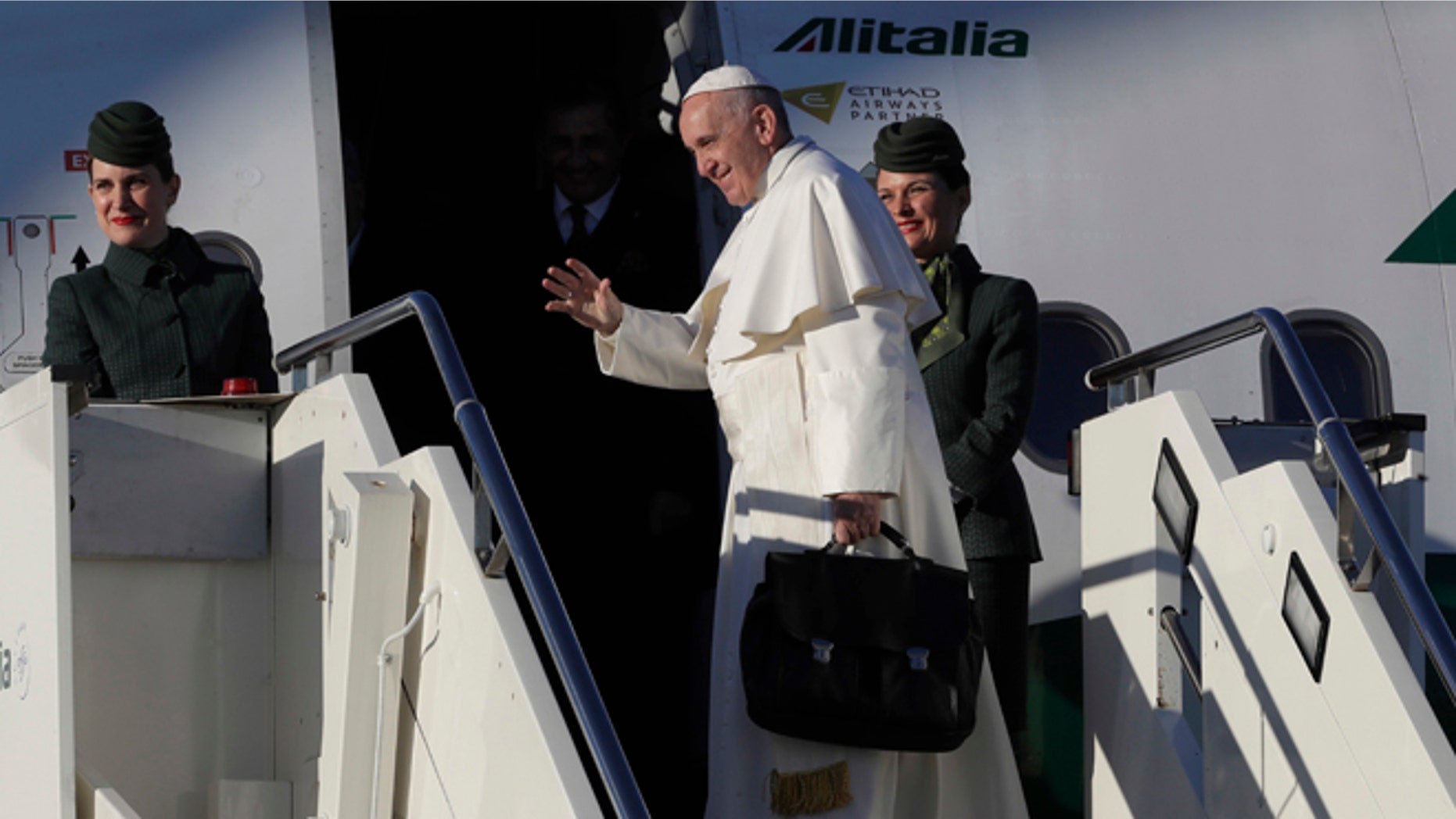 Pope Francis boards an airplane at Rome's Fiumicino international airport, on his way to Malmo, Sweden, Monday, Oct. 31, 2016. Pope Francis is heading to secular Sweden to mark the 500th anniversary of the Protestant Reformation. (AP Photo/Alessandra Tarantino)