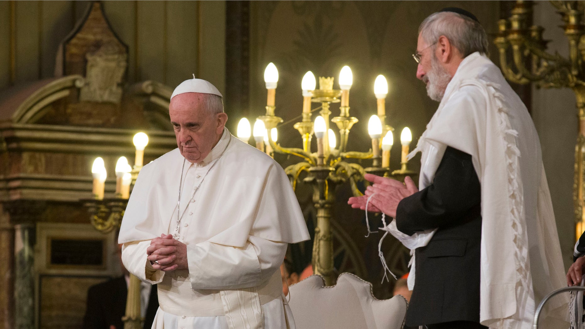Pope Francis flanked by Rabbi Riccardo Di Segni, right, during his visit to the Great Synagogue of Rome, Sunday, Jan. 17, 2016. Pope Francis made his first visit to a synagogue as pope Sunday, greeting Rome's Jewish community in their house of worship as his two predecessors did in a show interfaith friendship at a time of religiously-inspired violence around the globe. (AP Photo/Alessandra Tarantino)