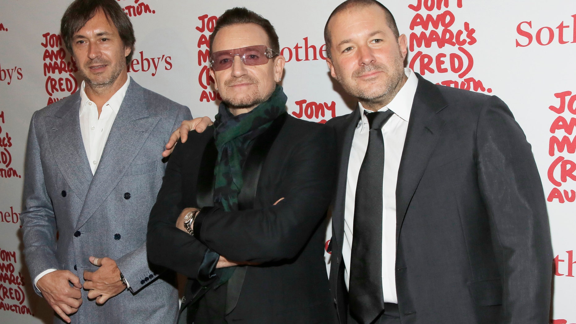 Designer Marc Newson (L), Singer Bono (C) and Apple's Senior Vice President of Design Jony Ive attend Jony And Marc's (RED) Auction at Sotheby's in New York Nov. 23, 2013.