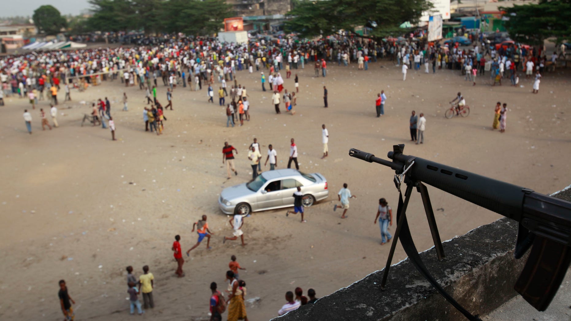 Jan. 5, 2011: A sniper stands guard over a public square ahead of the arrival of Charles Ble Goude, a youth leader recently named to Laurent Gbagbo's cabinet who is staging rallies in support of the incumbent president, in the Koumassi neighborhood of Abidjan, Ivory Coast. While the United Nations and other world powers recognize rival Alassane Ouattara as the winner of November presidential elections, Gbagbo has refused to step down for more than a month after the presidential runoff vote. The 15-nation regional bloc ECOWAS has threatened to remove the incumbent leader if ongoing negotiations fail.