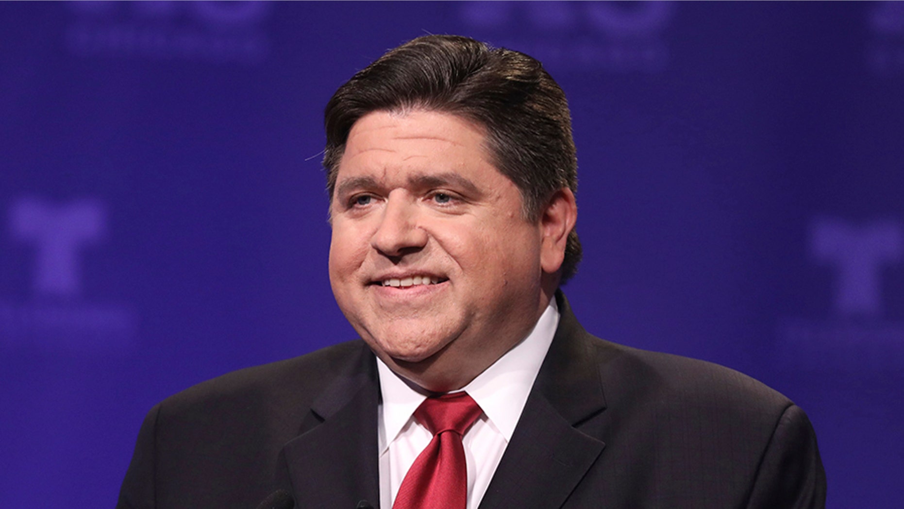 Democratic candidate for Illinois governor J.B. Pritzker takes his podium position before a televised forum Tuesday, Jan. 23, 2018, in Chicago. Six Democrats are vying for the chance to unseat Republican Gov. Bruce Rauner on March 20. (John J. Kim/Chicago Tribune via AP, Pool)
