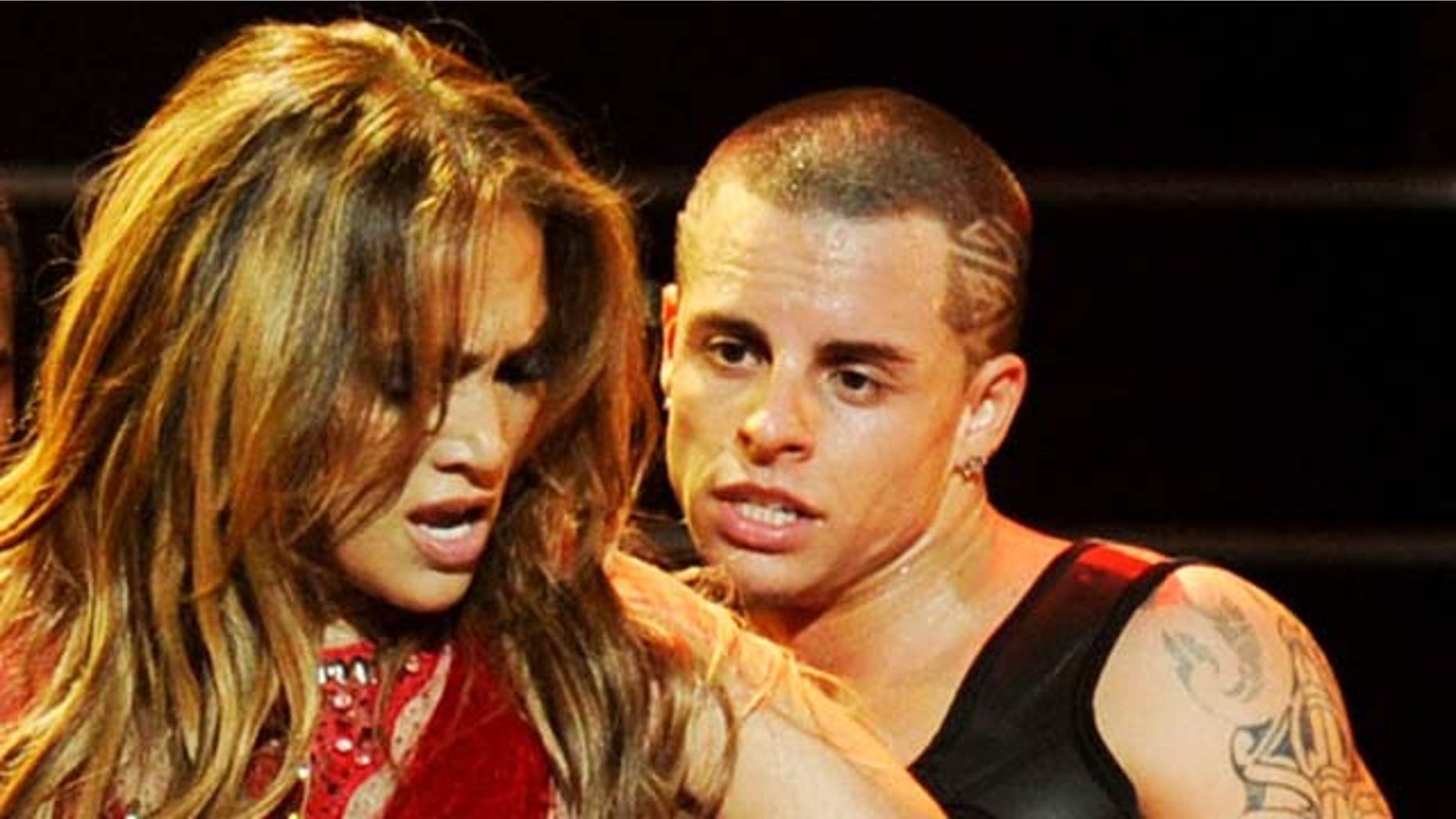 LAS VEGAS, NV - SEPTEMBER 24: Singer Jennifer Lopez and dancer Casper Smart (3R) perform onstage at the iHeartRadio Music Festival held at the MGM Grand Garden Arena on September 24, 2011 in Las Vegas, Nevada. (Photo by Ethan Miller/Getty Images for Clear Channel)