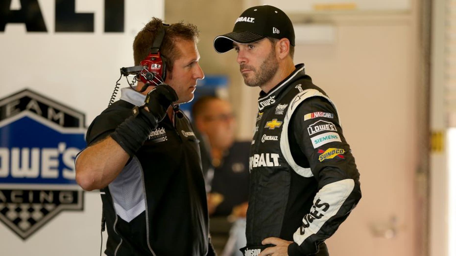 INDIANAPOLIS, IN - JULY 24: Jimmie Johnson, driver of the #48 Kobalt Tools Chevrolet, stands in the garage during practice for the NASCAR Sprint Cup Series Crown Royal Presents the Jeff Kyle 400 at the Brickyard at Indianapolis Motorspeedway on July 24, 2015 in Indianapolis, Indiana. (Photo by Andy Lyons/Getty Images)