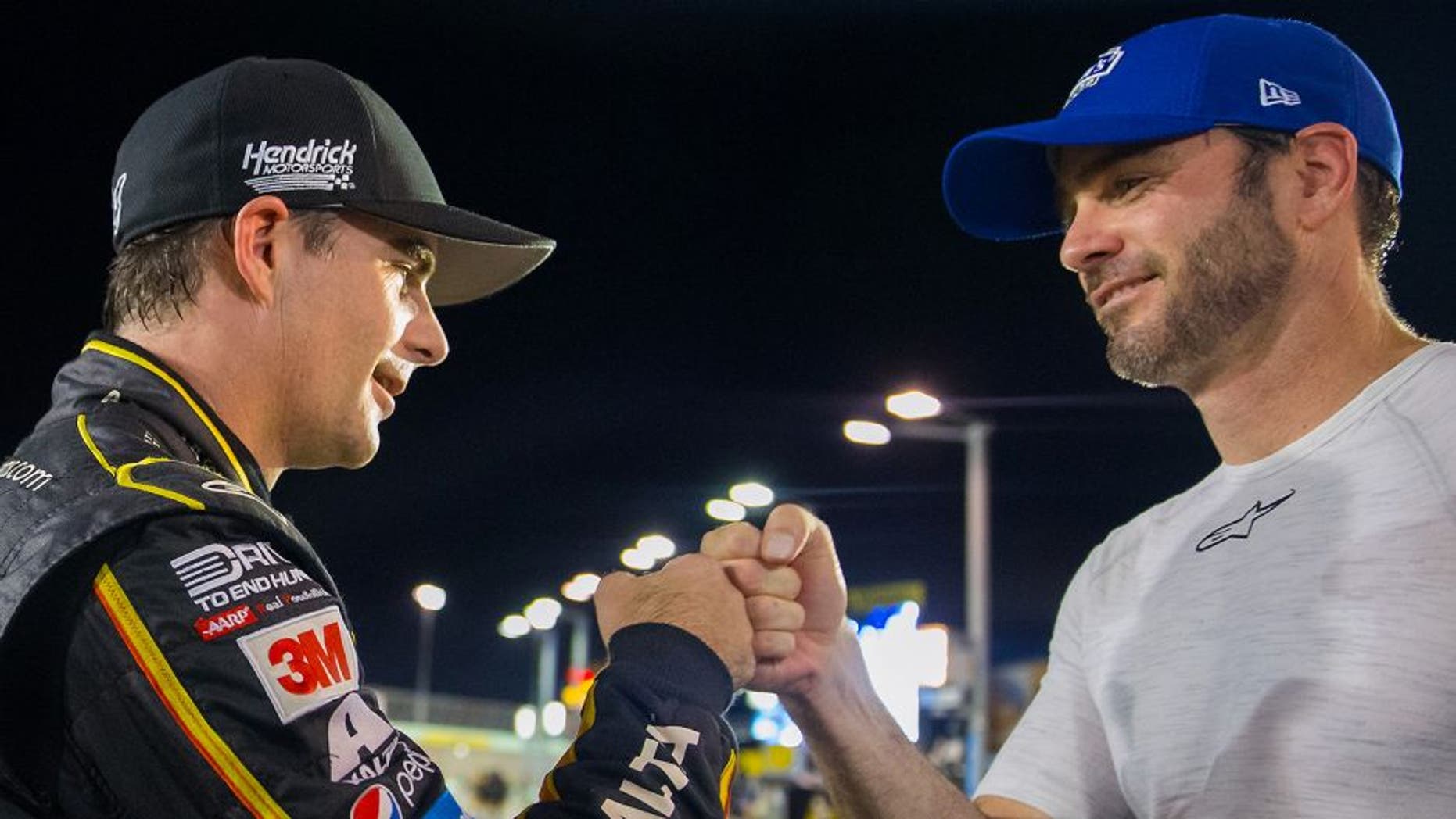 Nov 20, 2015; Homestead, FL, USA; NASCAR Sprint Cup Series driver Jeff Gordon (left) fist bumps teammate Jimmie Johnson following qualifying for the Ford Ecoboost 400 at Homestead-Miami Speedway. Mandatory Credit: Mark J. Rebilas-USA TODAY Sports