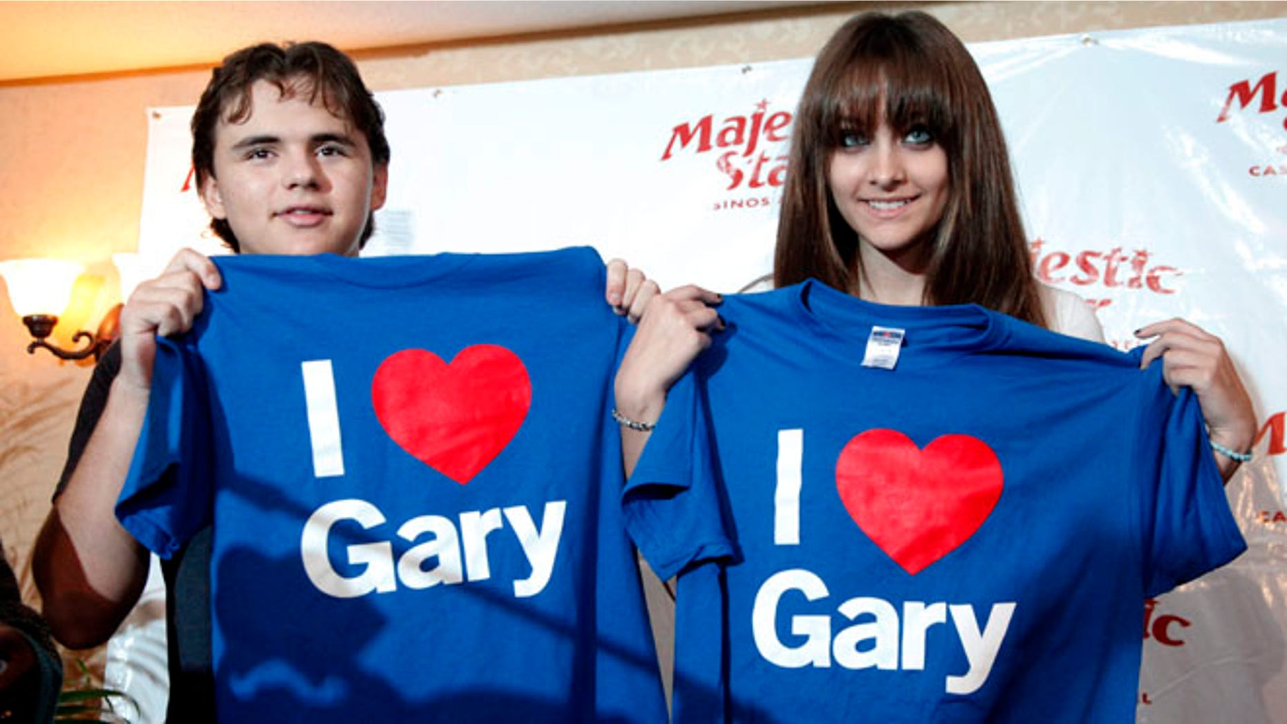 Aug. 29, 2012: Prince, left, and Paris Jackson, son and daughter to the late pop icon Michael Jackson, display T-shirts given to them by Gary Mayor Karen Freeman-Wilson in Gary, Ind.