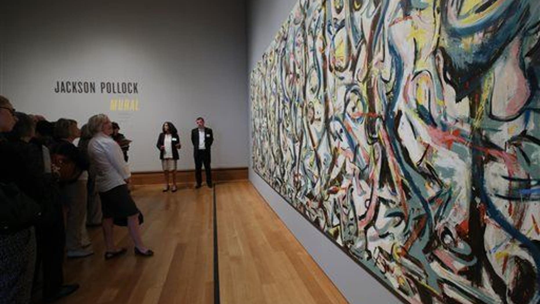 Members of the media preview Jackson Pollock's ���Mural,��� 1943, at the J. Paul Getty Museum in Los Angeles on Monday, March 10, 2014.