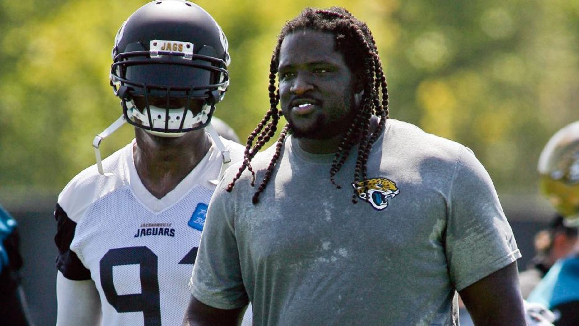 Jun 16, 2015; Jacksonville, FL, USA; Jacksonville Jaguars defensive end Chris Clemons (91) and defensive tackle Sen'Derrick Marks (99) during minicamp at the Florida Blue Health and Wellness Practice Fields. Mandatory Credit: Phil Sears-USA TODAY Sports