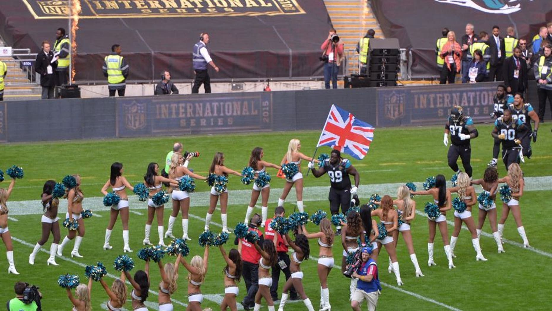 Oct 25, 2015; London, United Kingdom; Jacksonville Jaguars defensive tackle Sen'Derrick Marks (99) carries a British flag on the the field before the NFL International Series game against the Buffalo Bills at Wembley Stadium. Mandatory Credit: Kirby Lee-USA TODAY Sports