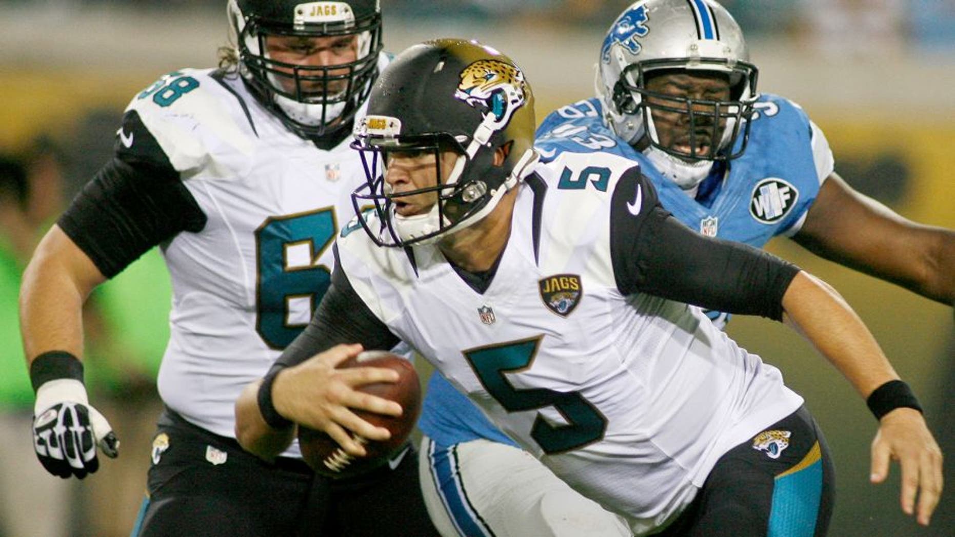 Aug 28, 2015; Jacksonville, FL, USA; Jacksonville Jaguars quarterback Blake Bortles (5) runs away from Detroit Lions defensive tackle Tyrunn Walker (93) in the first quarter of a preseason NFL football game at EverBank Field. Mandatory Credit: Phil Sears-USA TODAY Sports