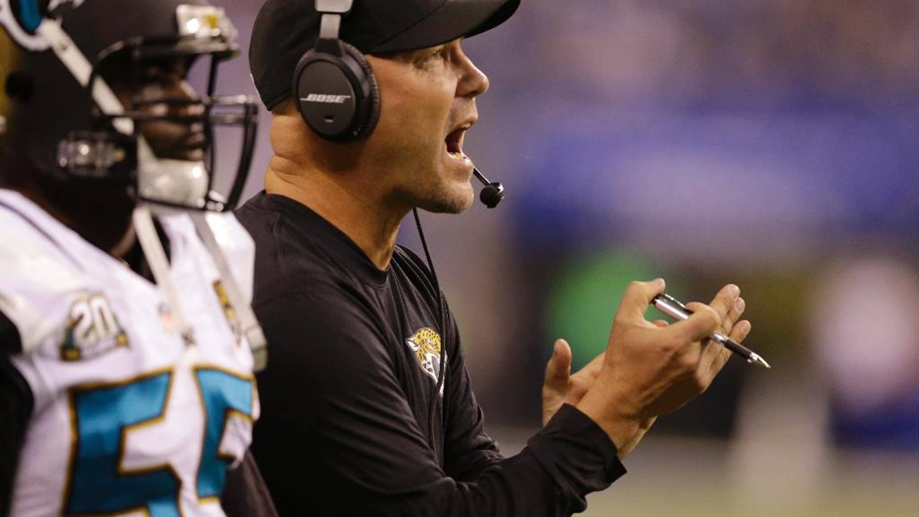 Jacksonville Jaguars head coach Gus Bradley cheers for his team during the first half of an NFL football game against the Indianapolis Colts, Sunday, Nov. 23, 2014, in Indianapolis. (AP Photo/Michael Conroy)