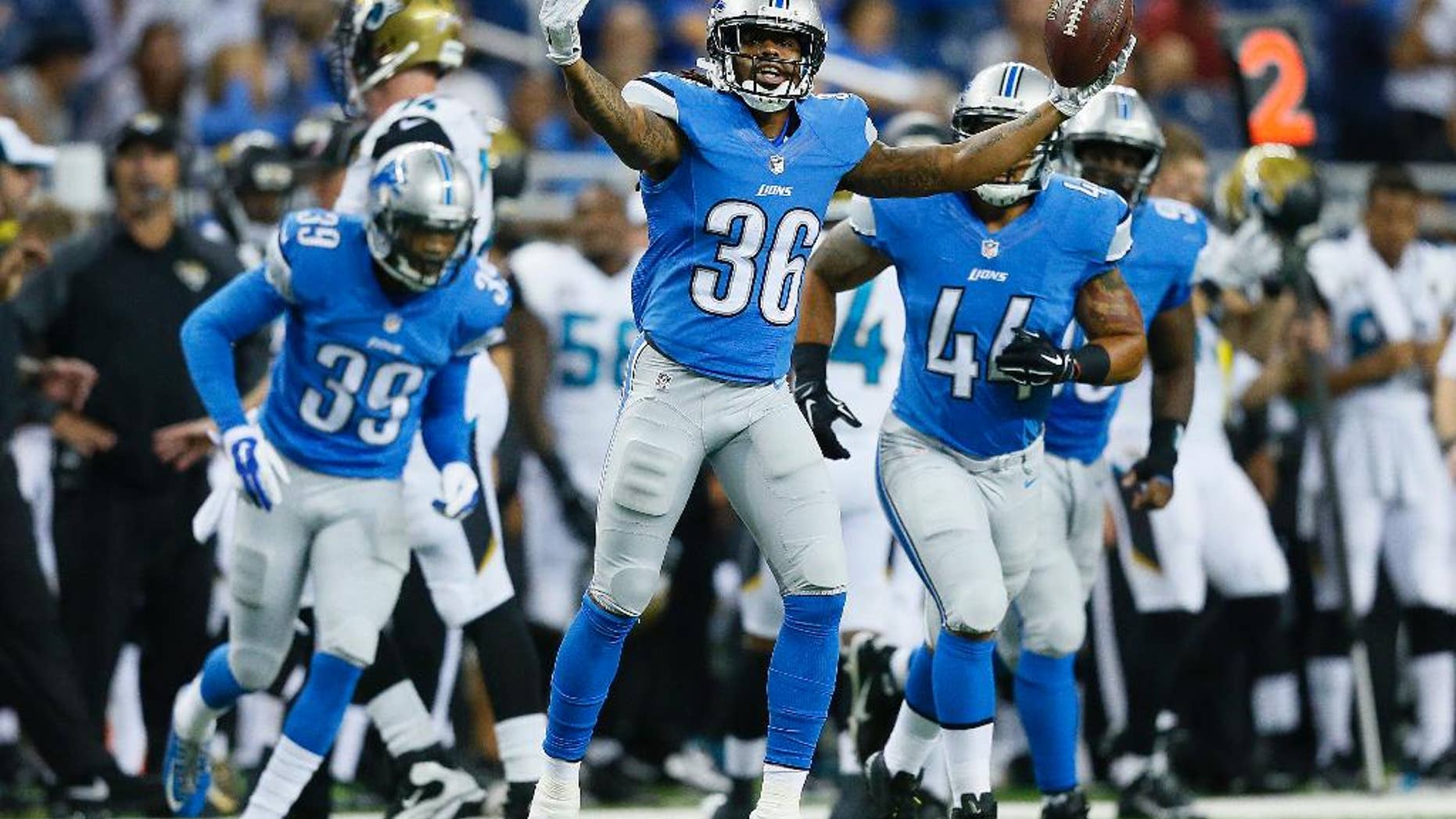 Detroit Lions cornerback Jonte Green (36) celebrates intercepting a Jacksonville Jaguars quarterback Ricky Stanzi pass in the second half of a preseason NFL football game at Ford Field in Detroit, Friday, Aug. 22, 2014. (AP Photo/Rick Osentoski)