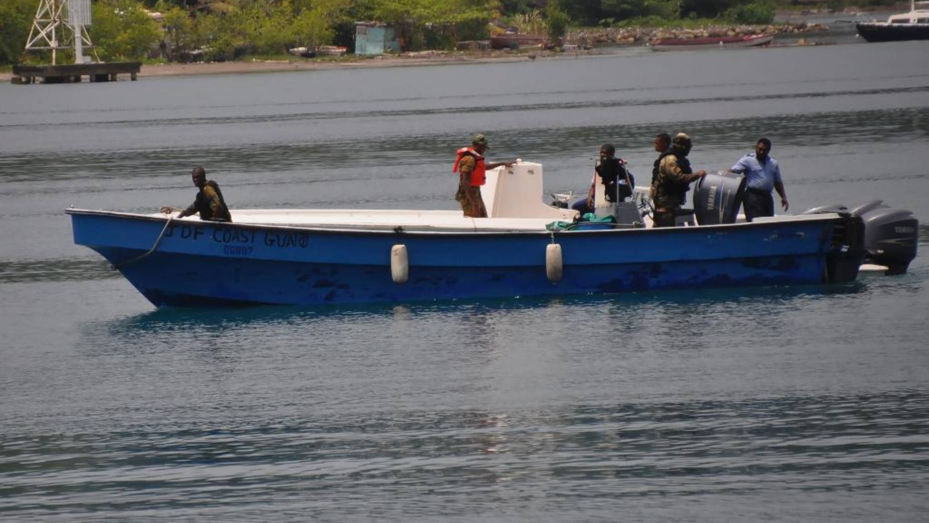 Jamaican Defence Force members return to Port Antonio Marina in Portland, Jamaica, Saturday, Sept. 6, 2014, after a fruitless search for a plane that crashed into the ocean a day earlier. Rescue crews searching off Jamaica's coast on Saturday said they could no longer see debris spotted earlier, stymieing efforts to solve the mystery surrounding a small plane carrying a prominent upstate New York couple that went on a ghostly 1,700-mile journey after the pilot was apparently incapacitated. Jamaican officials said that possible wreckage from the single-engine turboprop Socata TBM700 was sighted Friday evening by a military aircraft flying off the island's northeast coast, drifting roughly 24 miles off the coastal town of Port Antonio. (AP Photo/Everard Owen)