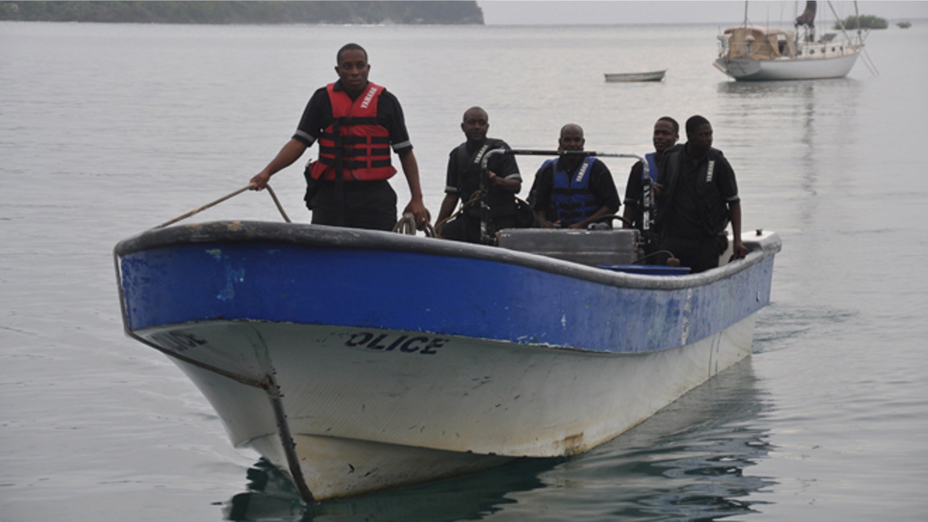 Jamaican Marine Police return to the Port Antonio Marina after a fruitless search for a plane that crashed into the ocean near Port Antonio, Jamaica, Friday, Sept. 5, 2014. A small plane flew down the Atlantic Coast and beyond Friday before finally crashing in the waters off Jamaica. The fate of the two or more people aboard was not immediately known. Maj. Basil Jarrett of the Jamaican Defense Force said the plane went down northeast of the coastal town of Port Antonio and the military dispatched two aircraft and a dive team. (AP Photo/Everard Owen)
